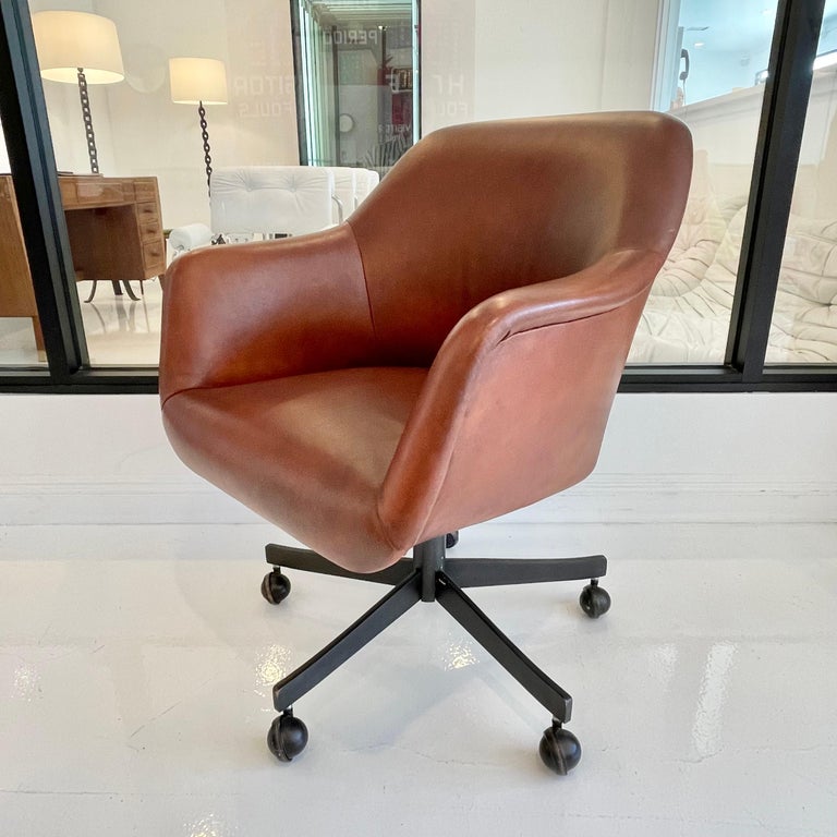 Elegant leather desk chair by Ward Bennett for Brickell Associates. Beautiful deep brown cowhide seat with oil rubbed bronze metal base. Reclines and swivels. Height is adjustable. Great vintage condition. Terribly comfortable. Very very good