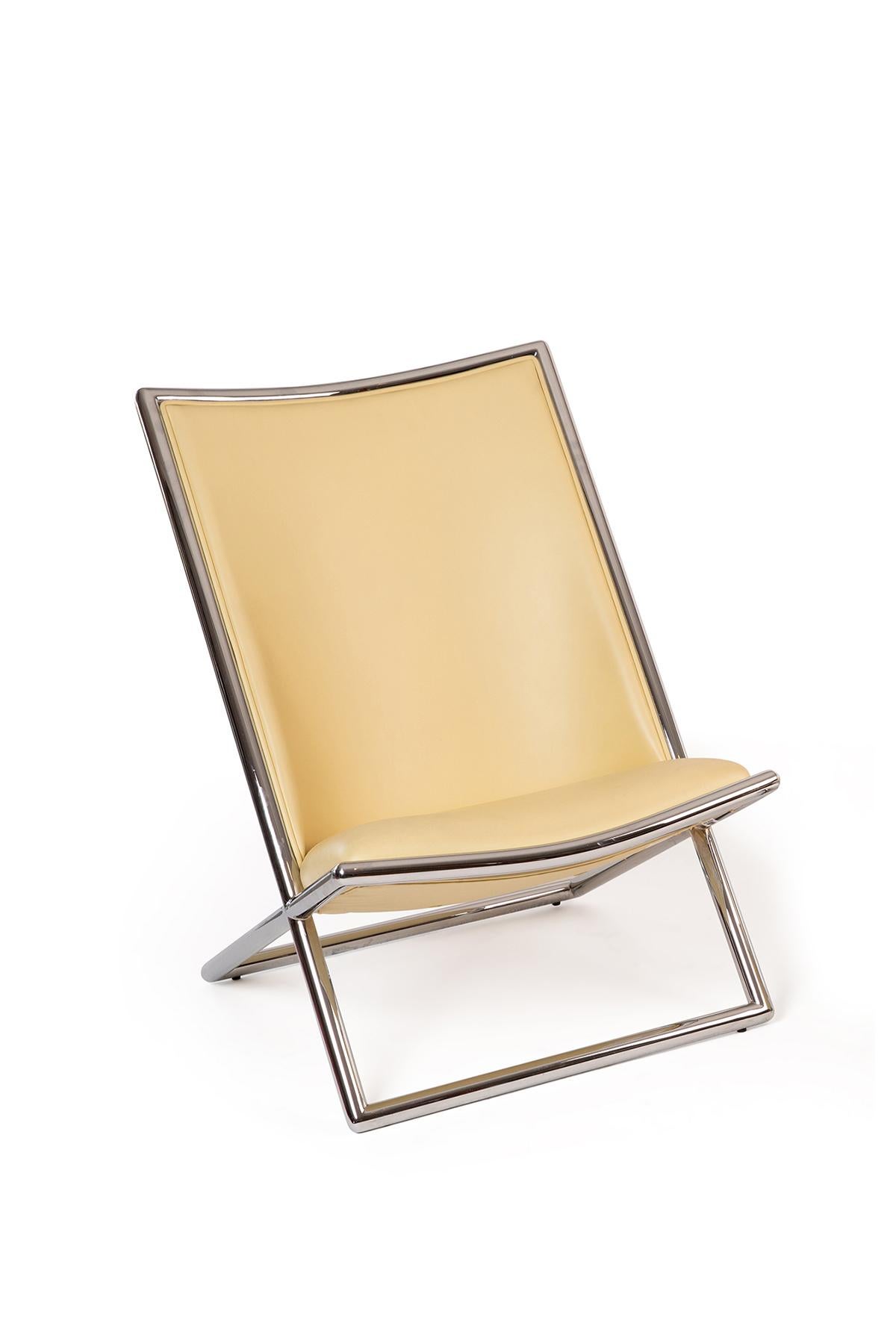 Low-slung pair of chrome-edged scissor lounge chairs in supple light yellow Edelman leather by Ward Bennett. Price listed is for the pair.