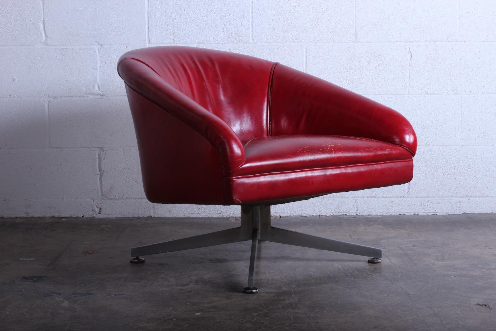 A Classic Ward Bennett lounge chair on aluminum base. The original leather has splits in the seams.