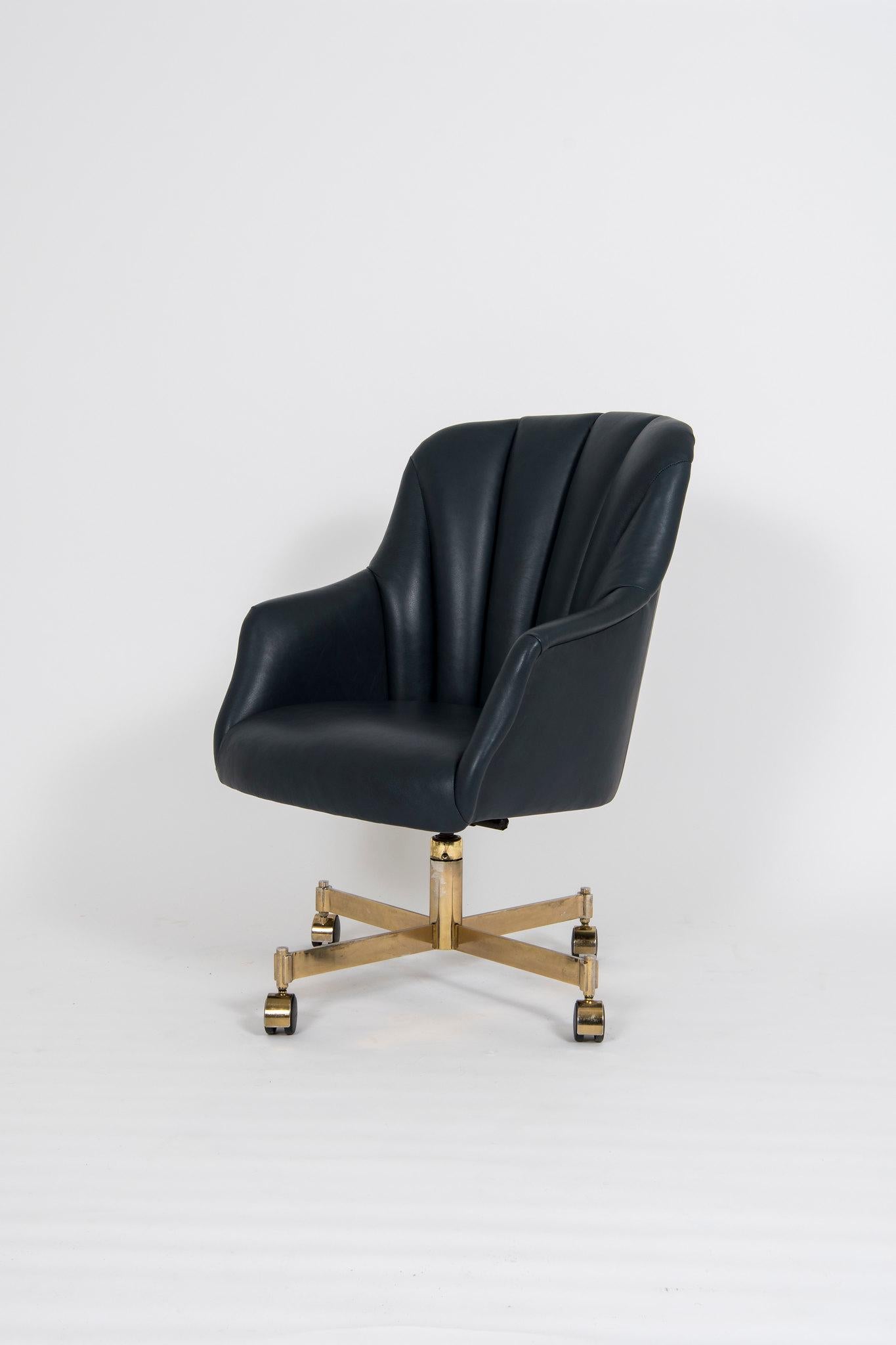 A vintage Ward Bennett for Brickel office or conference chair with brass spindle base newly upholstered in a handsome Navy Italian leather.



    