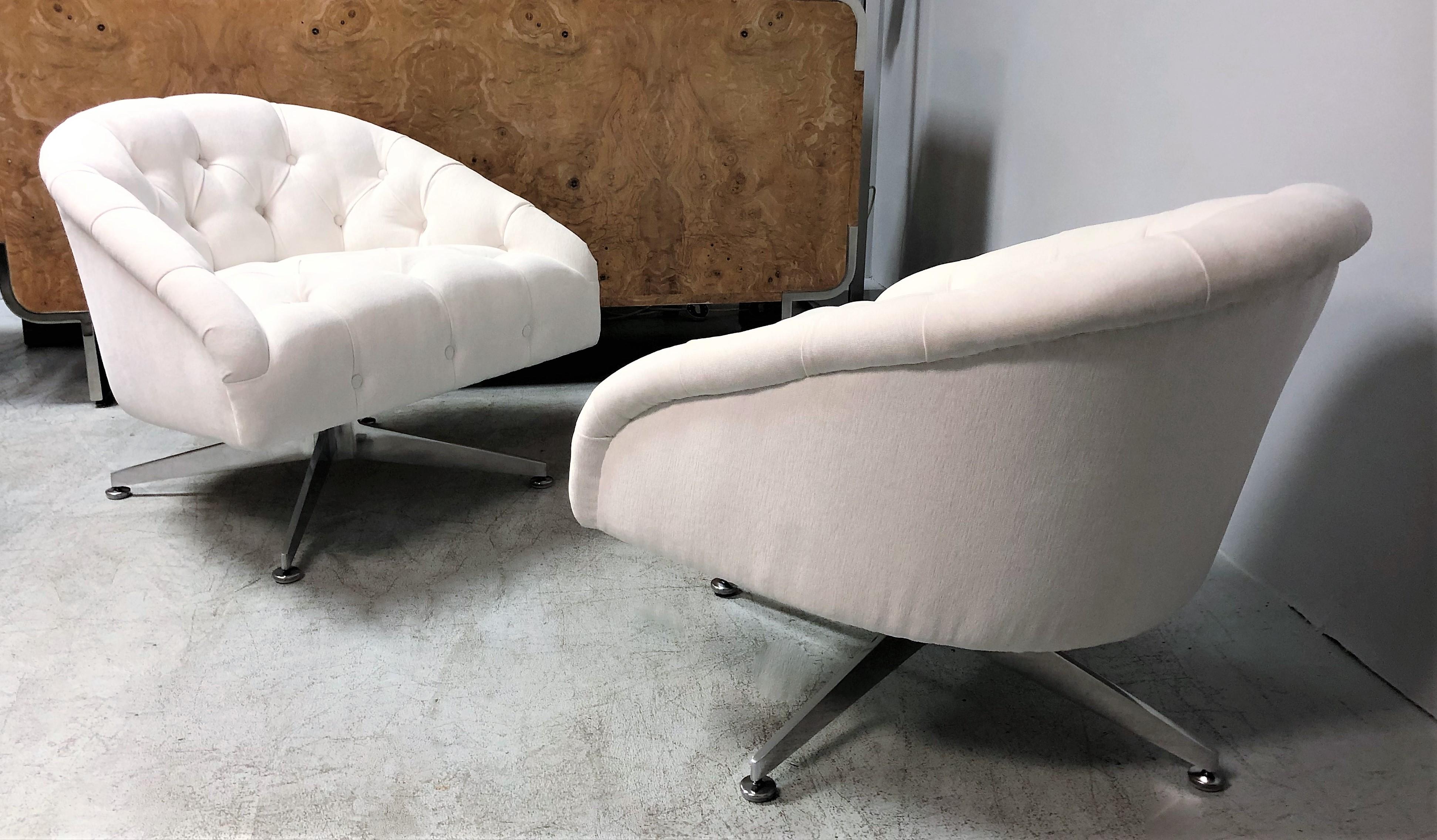 A pair of swivel chairs design by Ward Bennett and edited by Lehigh Leopold. They have a low modernist profile and an provocative inviting presence. The bases are a highlight of this design, solid thick gracefully robust aluminum that extend at a