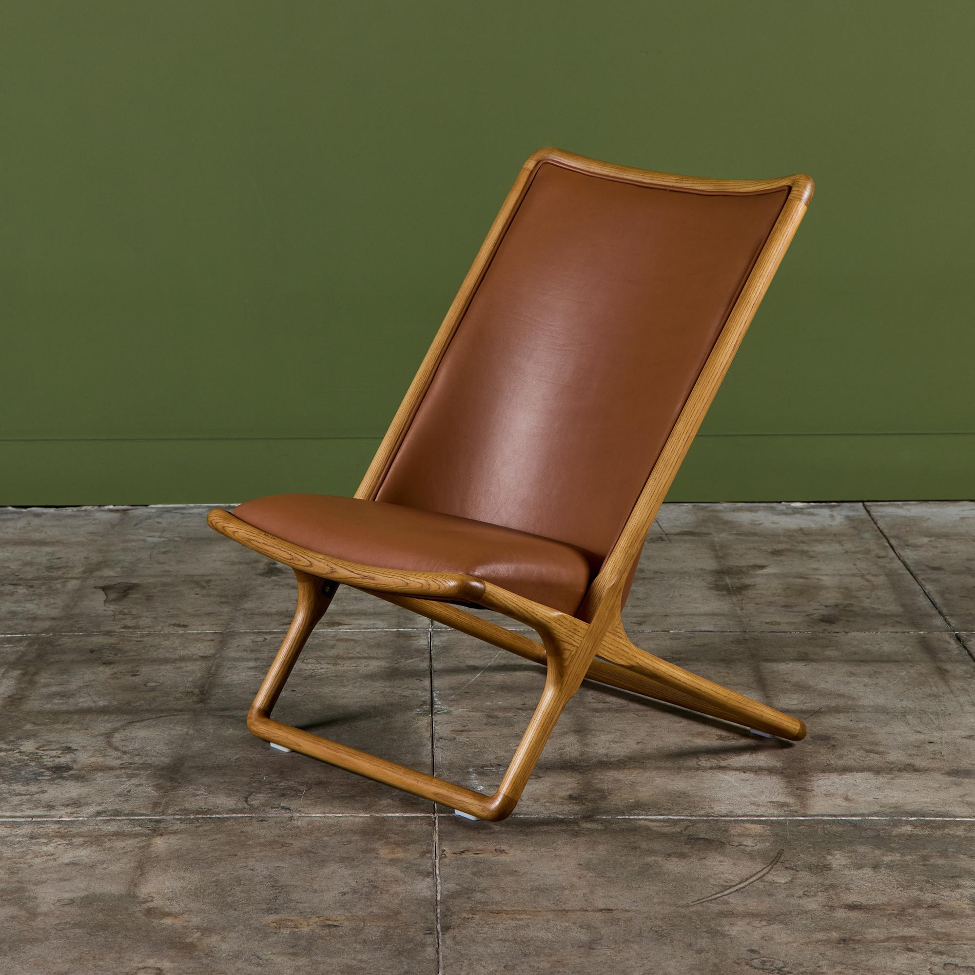 Scissor chair by Ward Bennett. This 1982 production of a 1960s design. It features an oak frame with caramel leather upholstery.

Dimensions
23.5” width x 27.5” depth x 34.5” height; 14.5