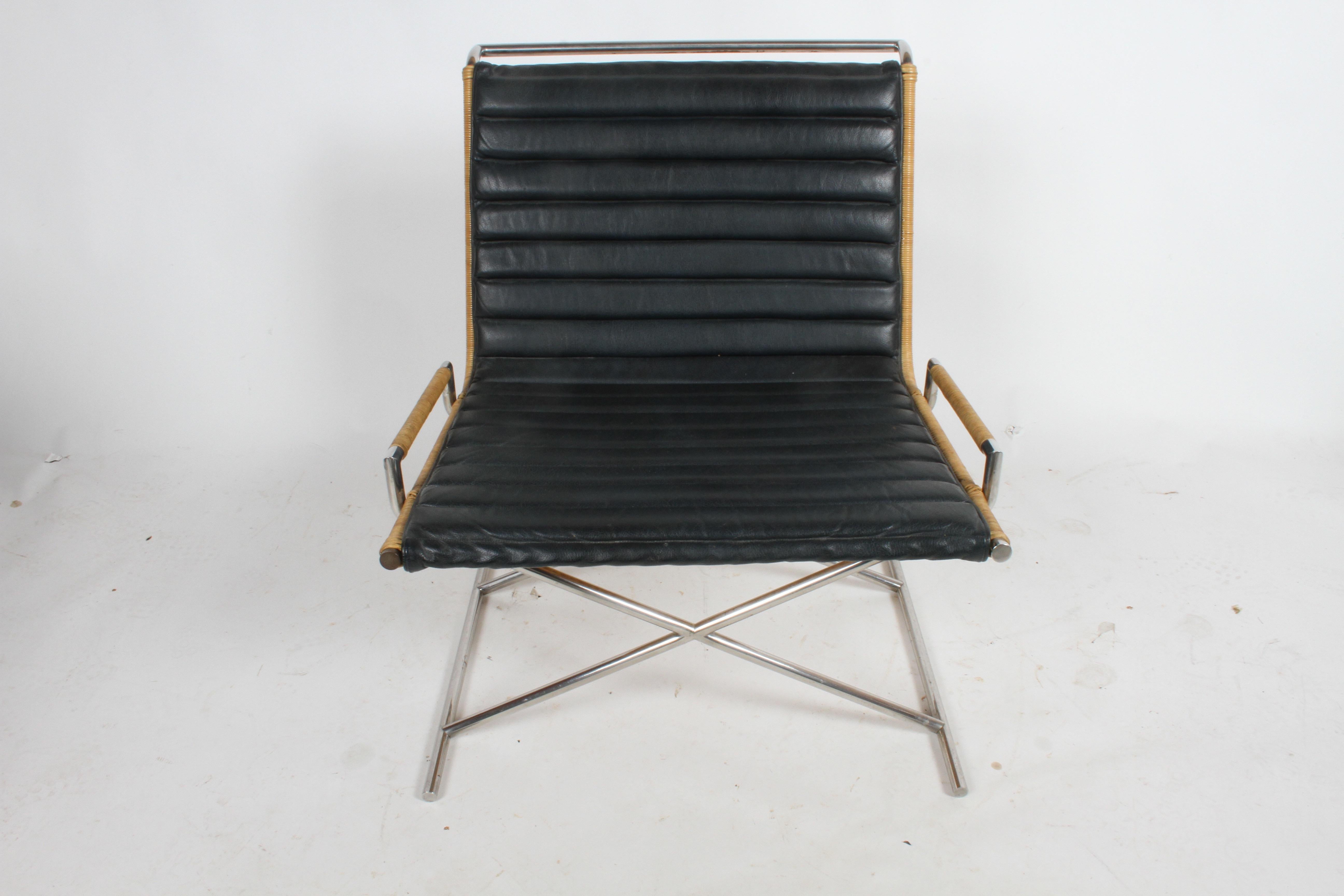 Striking all original Ward Bennett Sled chair with rattan, chrome frame and leather seat. Classic Bennett design with x form base. Minor wear to leather as to be expected, rattan is solid, tight and strong. Note: Front cap on left side front will be