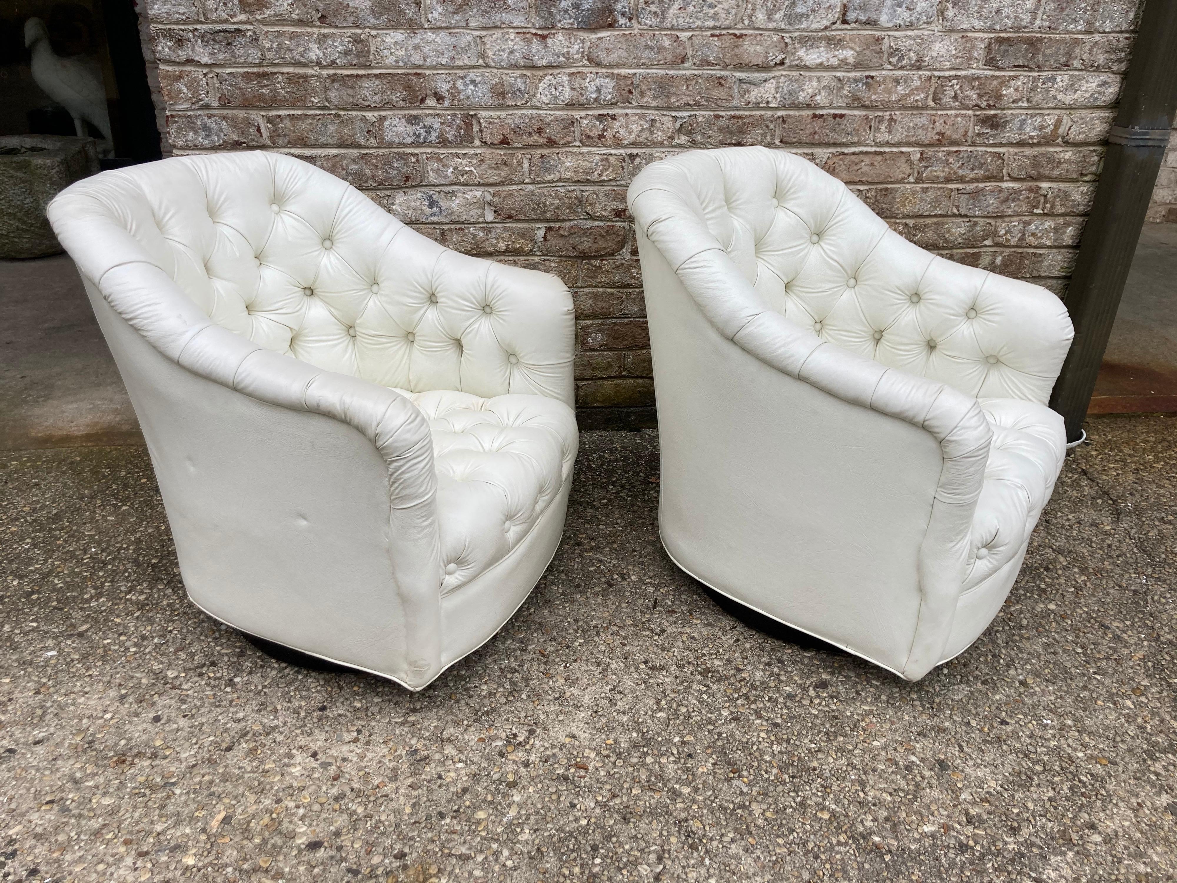 Pair of Ward Bennett style swivel armchairs in original white upholstery.