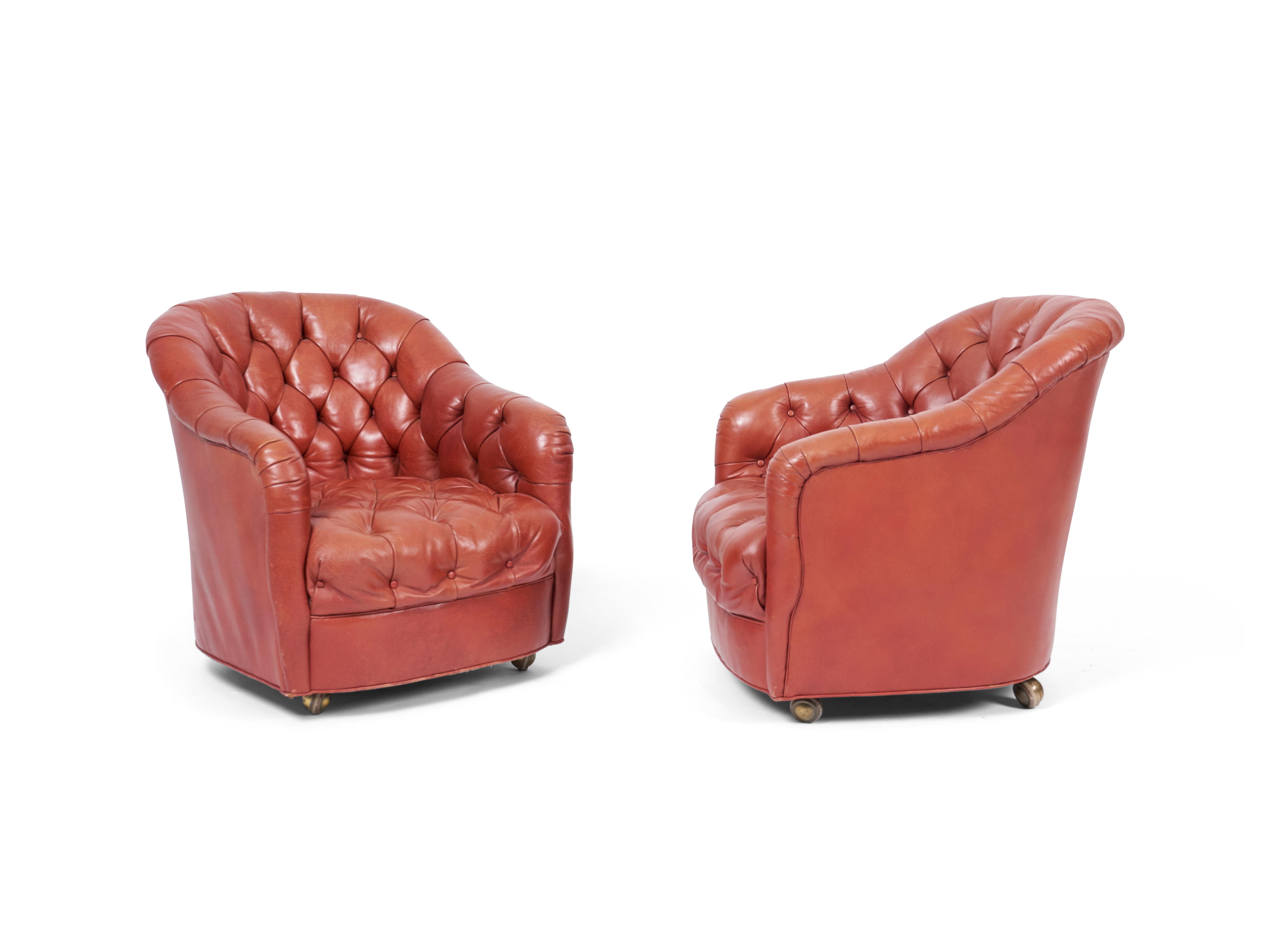 Chesterfield tufted lounge chairs by Ward Bennett for Brickell. Original brick red leather with castor wheels