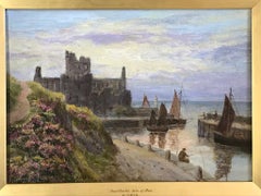 Peel Castle, Isle of Man with cliffs and boats in the harbour and soft light