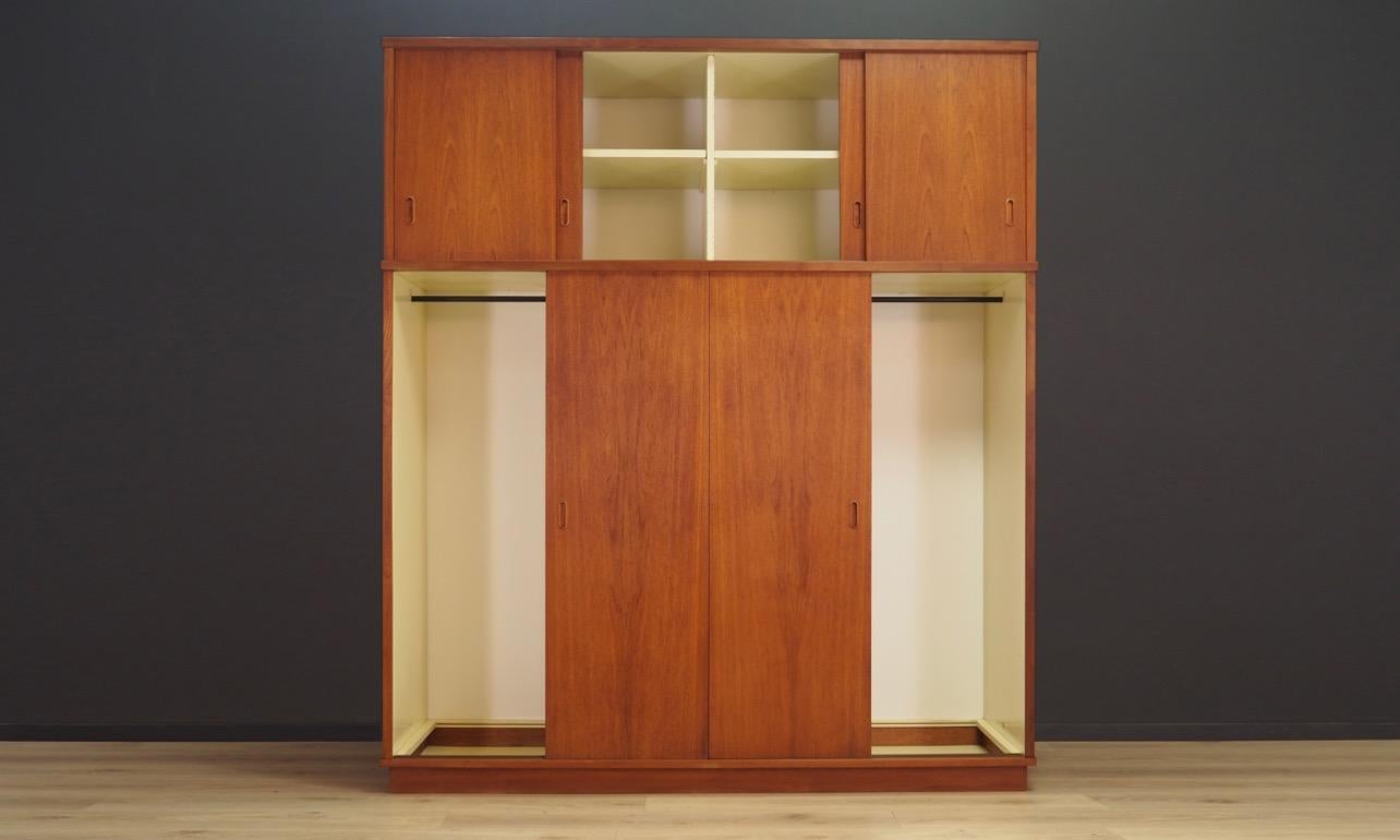 Fantastic wardrobe from the 1960s-1970s, Minimalist form - Scandinavian design. Finished with teak veneer. Inside numerous shelves and space for hangers. Preserved in good condition (minor bruises and scratches) - directly for use.

Dimensions: