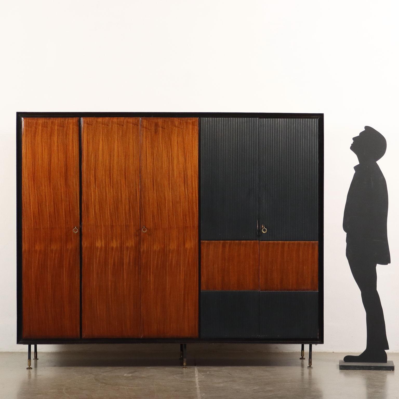 Wardrobe with 5 hinged doors in mahogany veneer with ebonized grissinature and polyester finish, metal and brass legs.