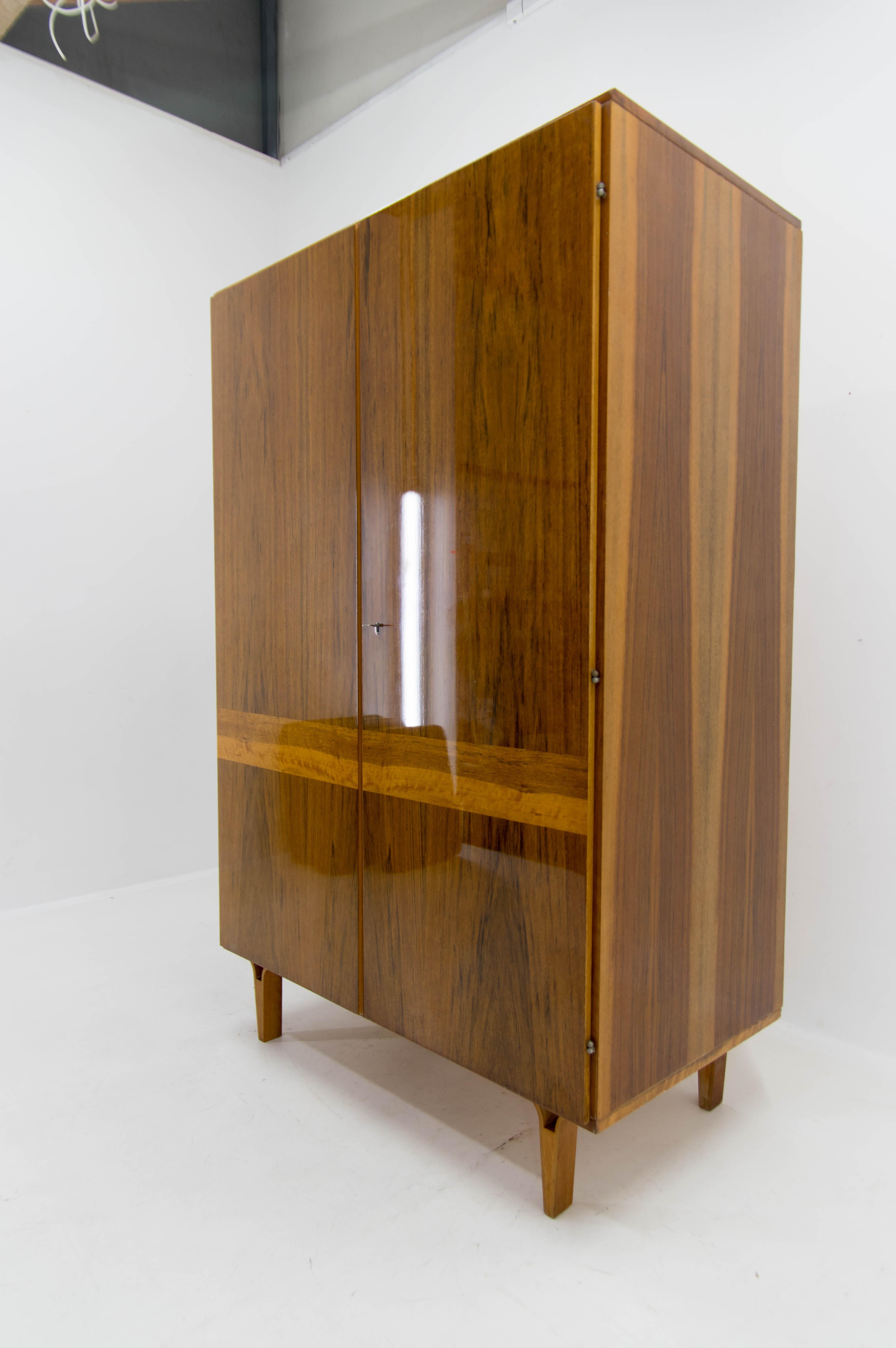 Design Mid-century wardrobe with shelf and two drawers designed by Frantisek Mezulanik and executed and labeled by Novy Domov in Czechoslovakia in 1974.
Elegant design legs made of plywood.
Veneer with high gloss finish in perfect condition.
Cleaned