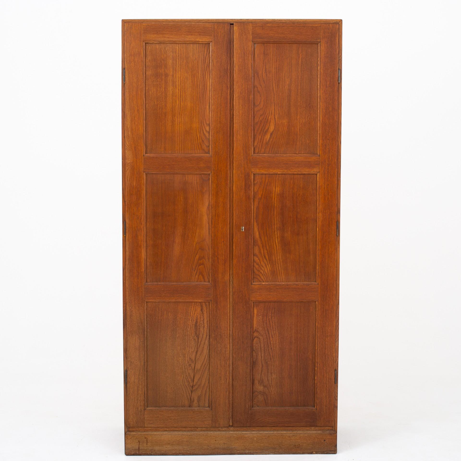 Wardrobe in solid, patinated oak with interior in pine. Minor slit on bottom left door. From circa 1935. Maker Rud Rasmussen.