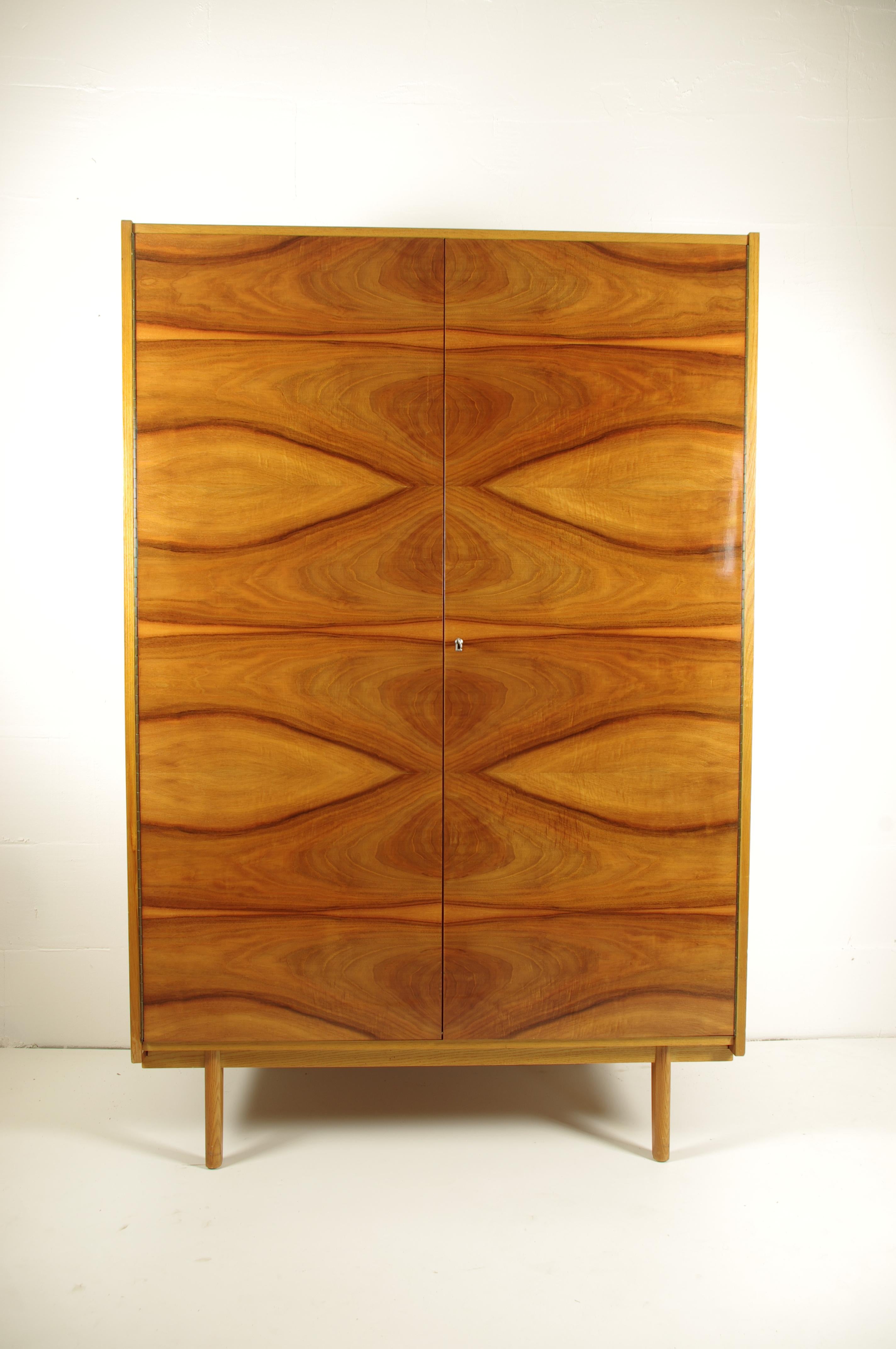 Made of wood and walnut veneer. The doors have high gloss finish. Manufactured by LIPA, Usti nad Labem, Czechoslovakia. Original, very preserved condition. Some sun fading on left side.