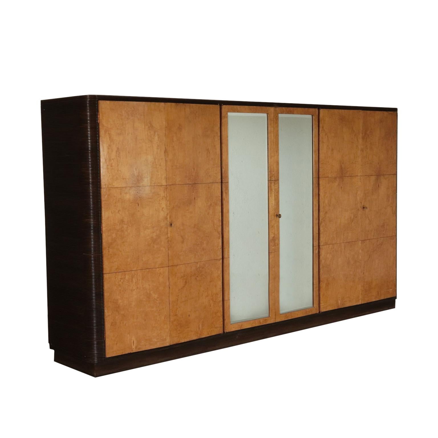 Wardrobe with swing doors. Burl veneered wood. Mirror and ruffled sides.