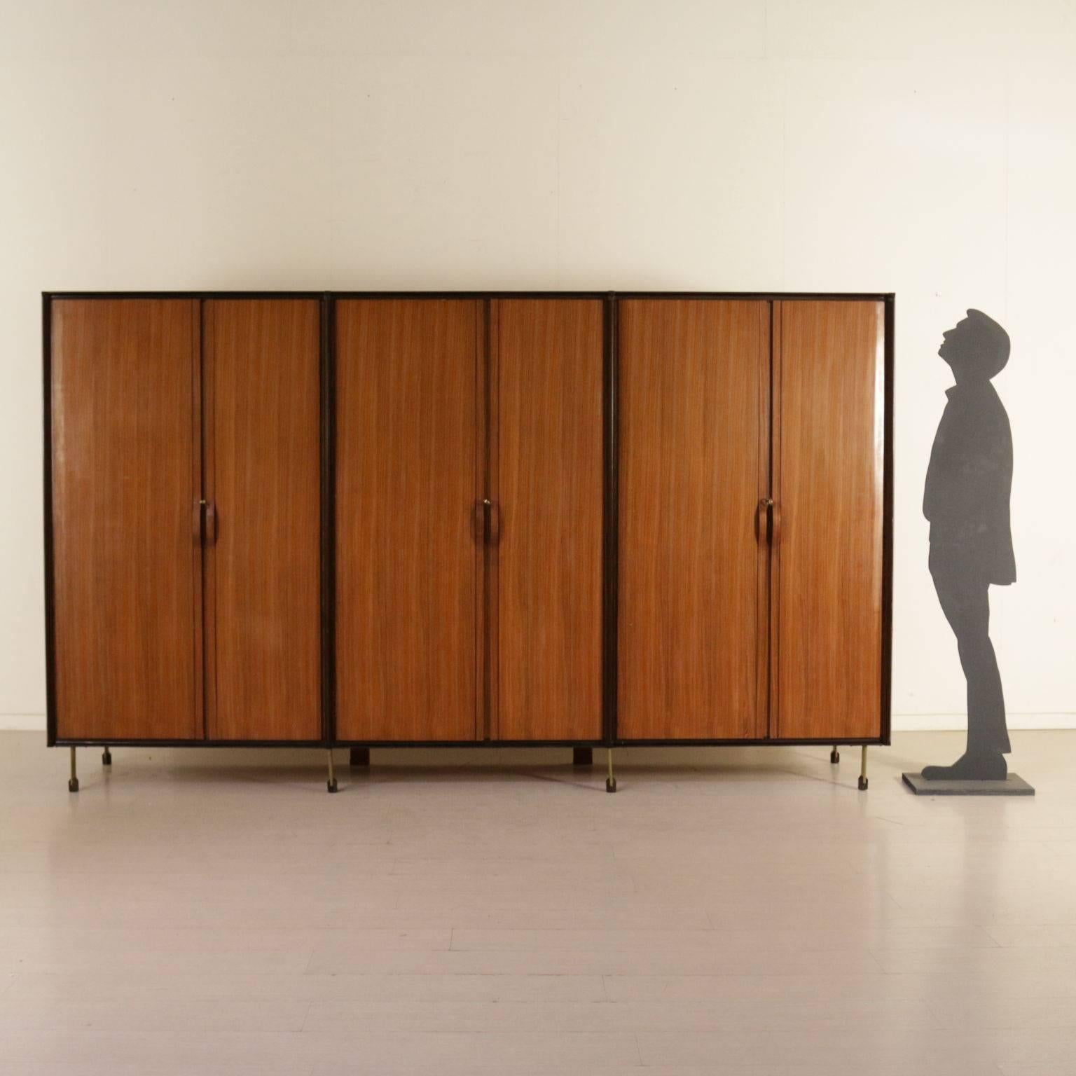 A wardrobe, rosewood veneer, metal and wooden legs. Manufactured in Italy, 1960s.