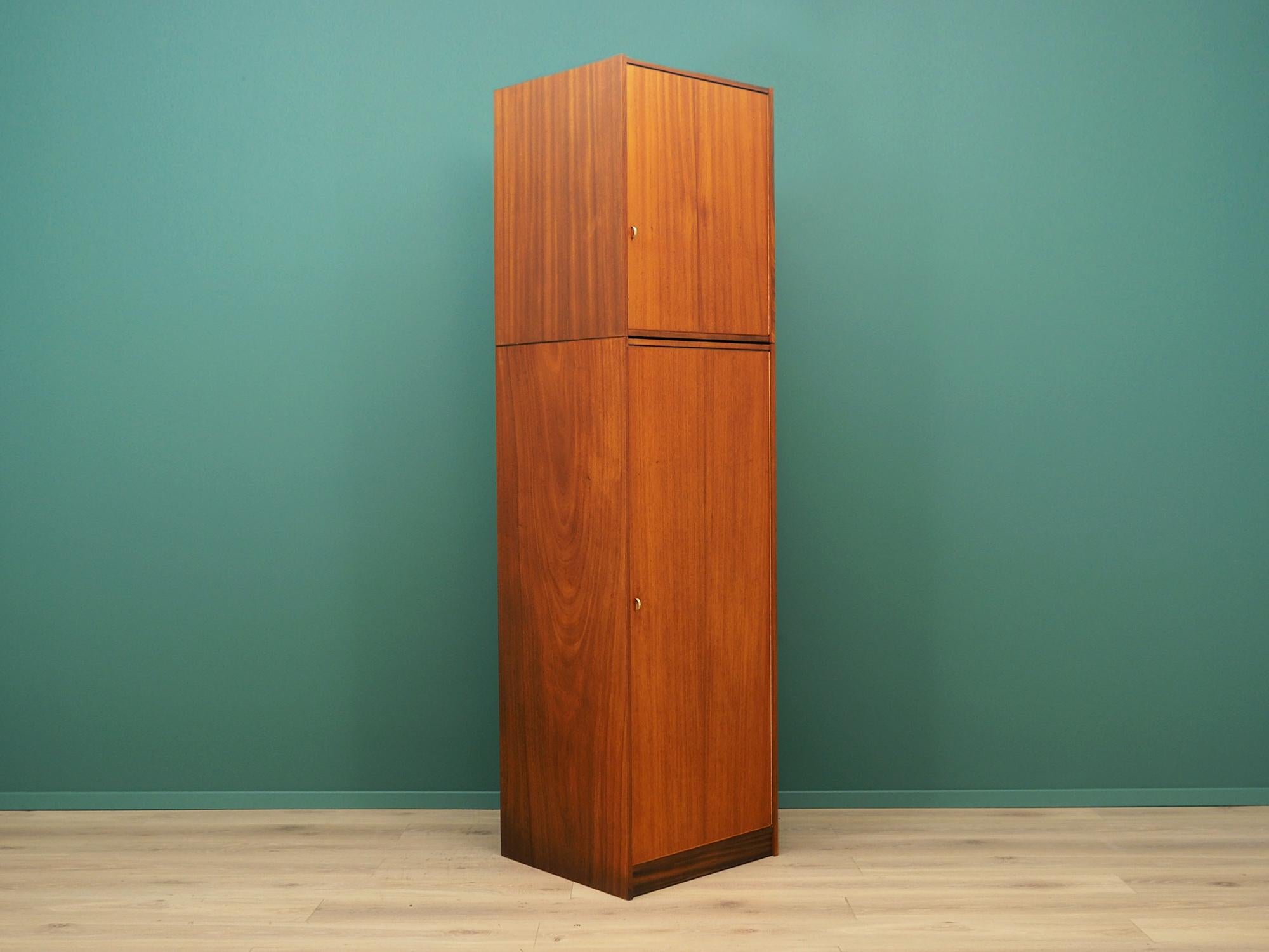 Scandinavian wardrobe from the 1960s-1970s. Danish design, Minimalist form. Surface of the furniture finished with teak veneer. In the lower section there is a handle for hangers and shelf in the upper. Preserved in good condition (minor bruises and