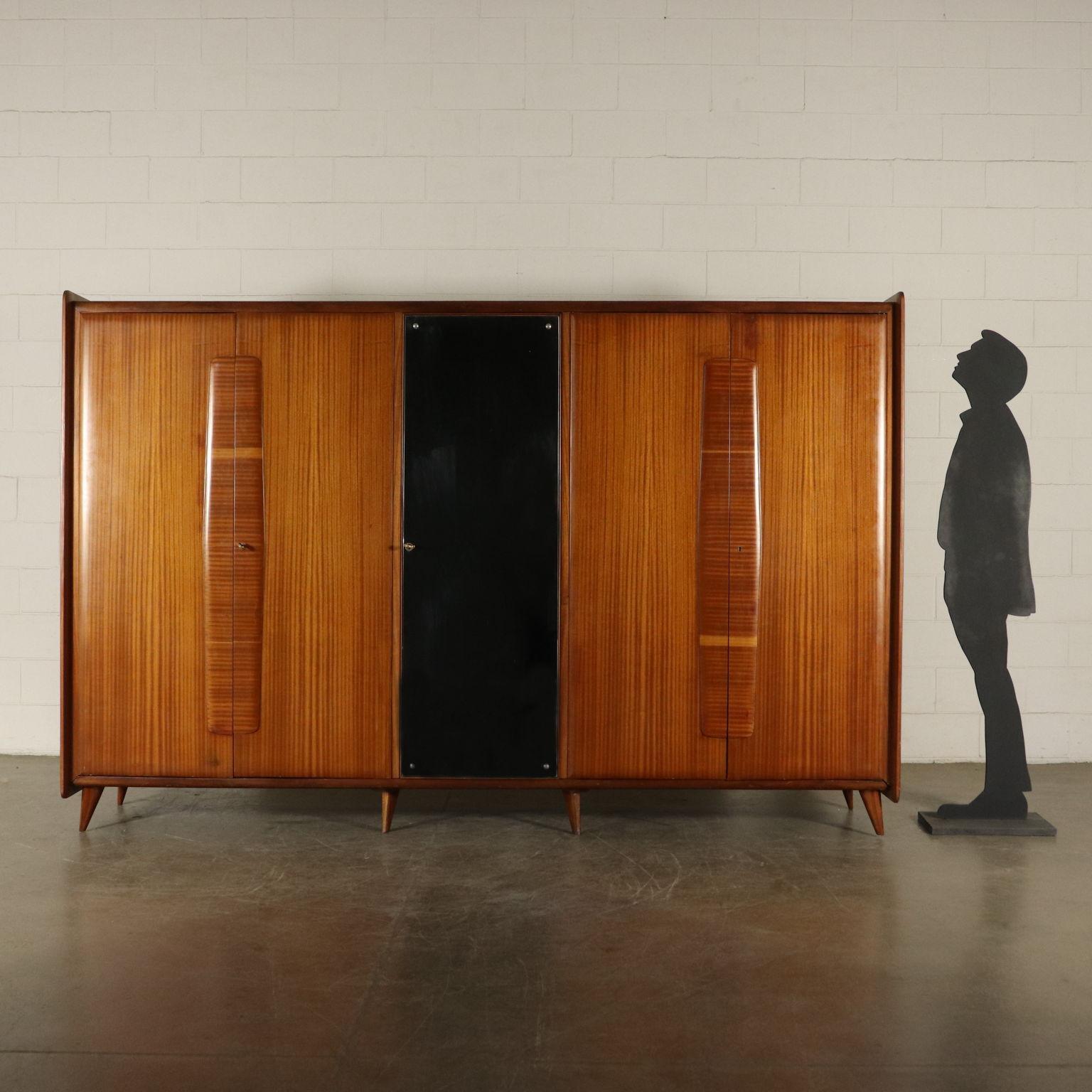 Wardrobe with hinged doors and mirror in the middle. Mahogany veneer. Manufactured in Italy, 1950s-1960s.