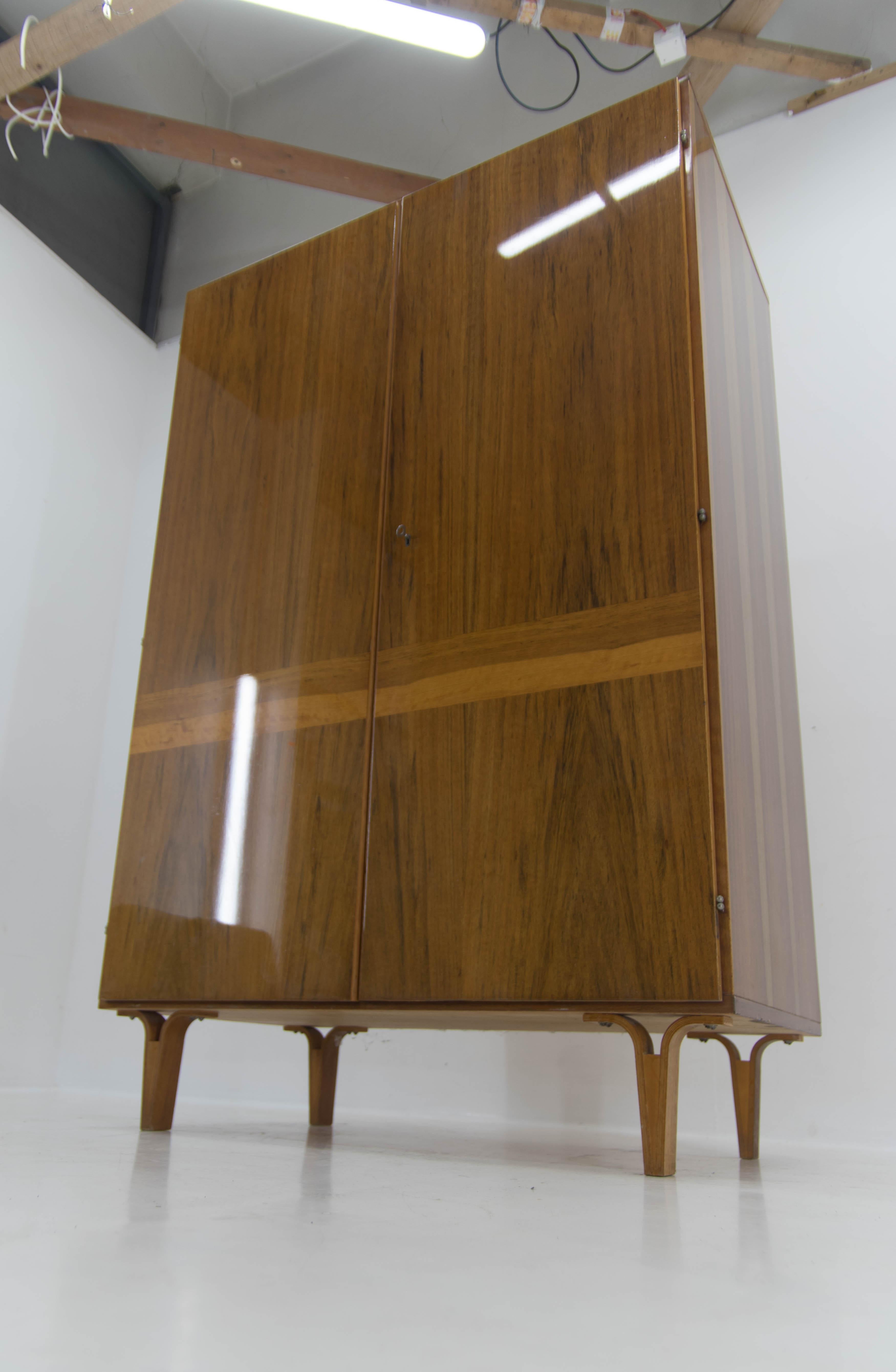 Design Mid-century wardrobe with mirror inside designed by Frantisek Mezulanik and executed and labeled by Novy Domov in Czechoslovakia in 1974.
Elegant design legs made of plywood.
Veneer with high gloss finish in perfect condition.
Cleaned and
