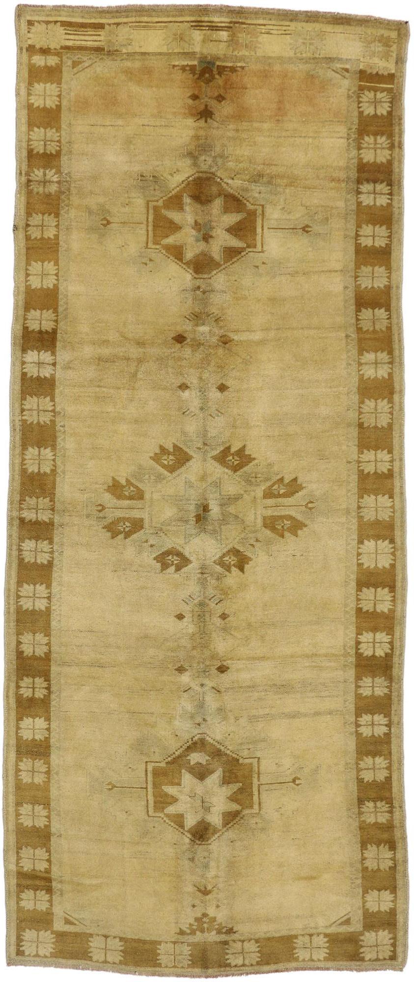 50447 Warm and Neutral Vintage Turkish Oushak Gallery Rug, Wide Hallway Runner 05'00 x 12'02. Soft and lustrous, the beauty of this Rustic style vintage Turkish Oushak runner lies in the timeworn abrash. Organic striations of color run along the