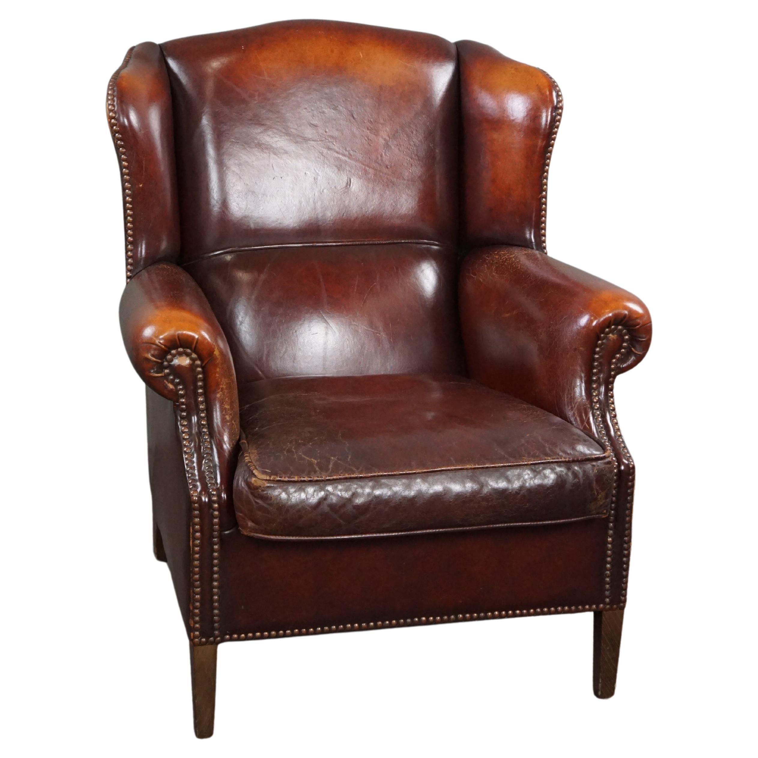 Warm brown sheep leather wing chair with character For Sale