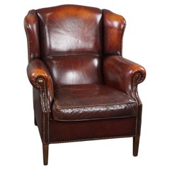 Fauteuil à oreilles de caractère en cuir de mouton marron chaud