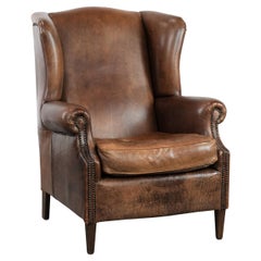 Warm, cosy and comfortable vintage sheepskin ear armchair with character