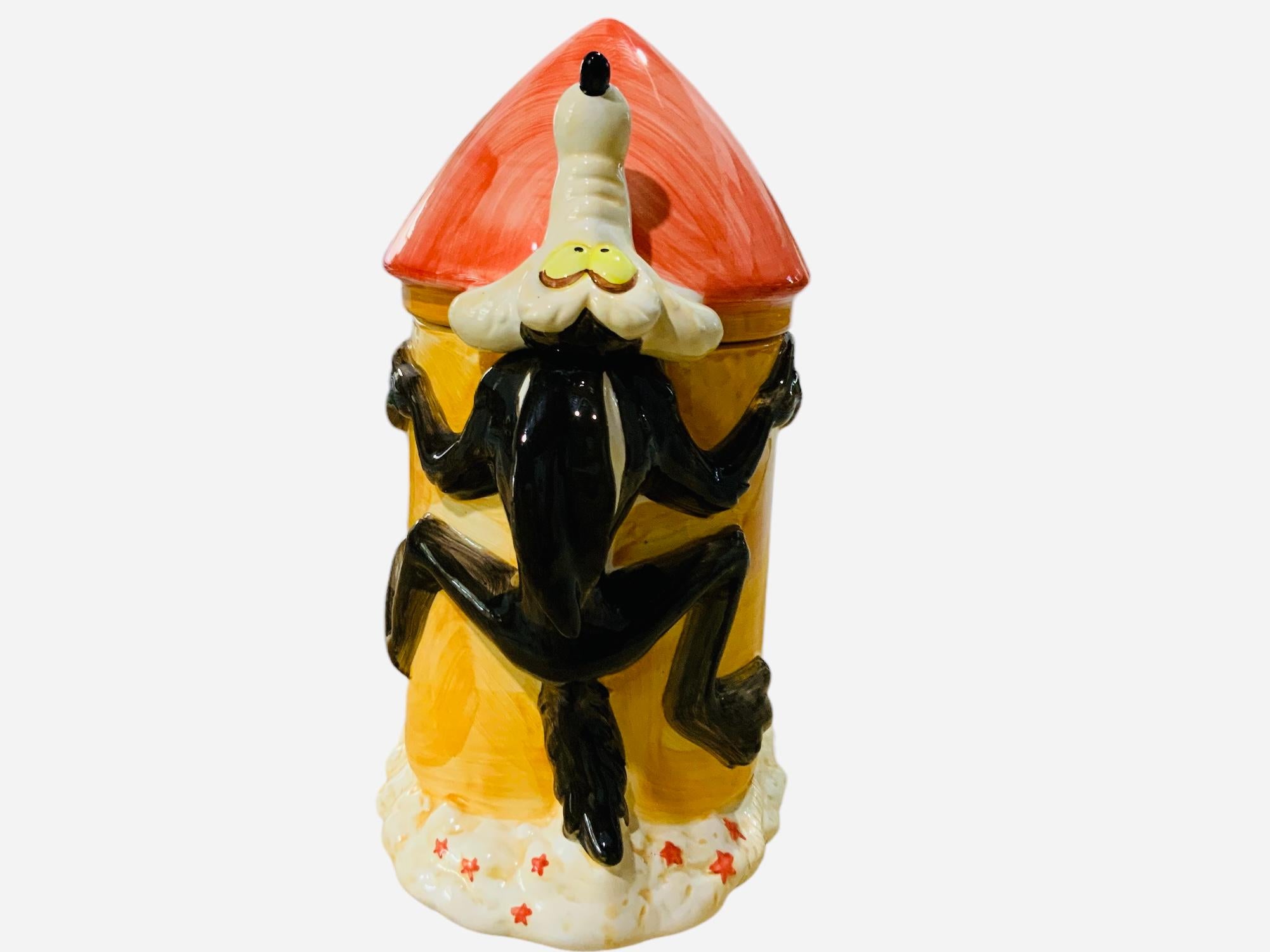 This is a Warner Bros, Looney Tunes Wile E. Coyote Rocket Cookie Jar. It depicts a hand painted ceramic cookie jar shaped as Wile E. Coyote ACME Rocket. Below the base is hallmarked TM & C; Warner Bros, Taiwan.