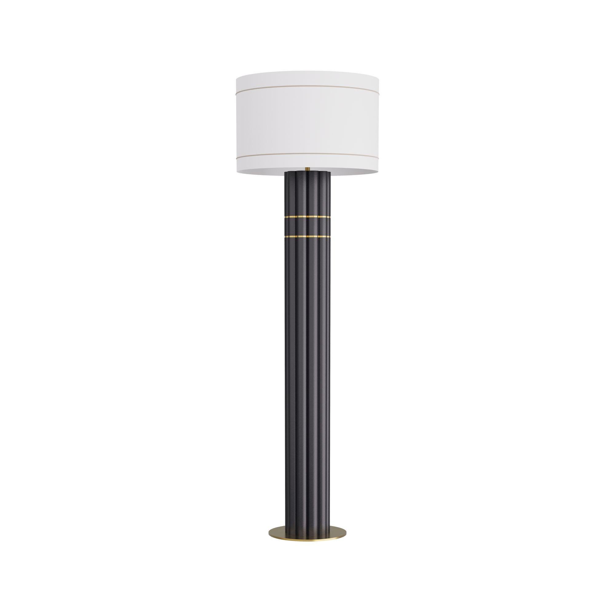 Warner Floor Lamp – A sophisticated blend of modern sculptural design and classic detail, the Warner floor lamp makes an elegant statement in a variety of interiors, from contemporary to transitional spaces. The lamp's column is thoughtfully crafted