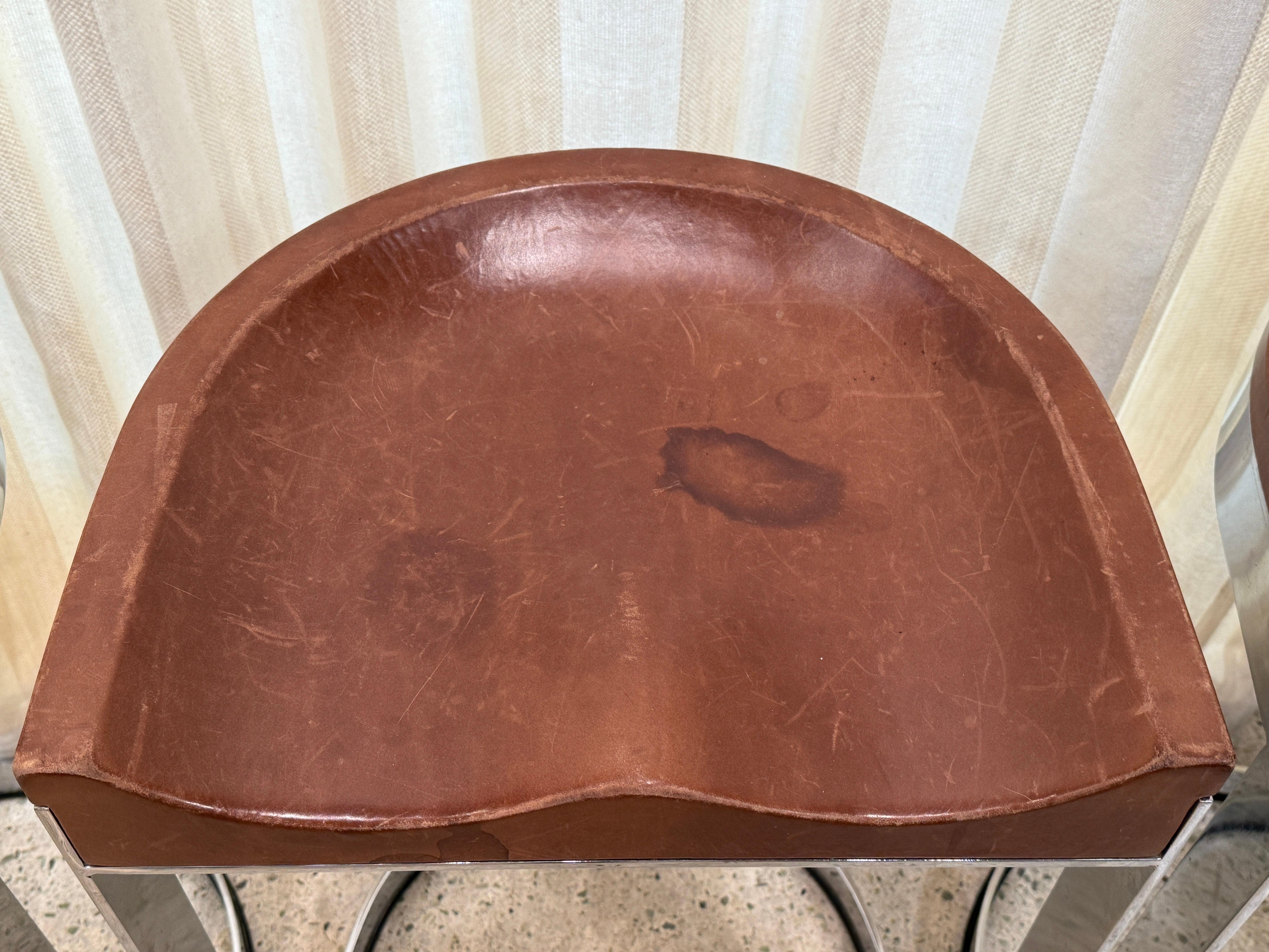 This set of THREE (3) Warren Bacon Counter height bar stools with molded leather seats and chrome cantilever bases.  Footrests in chrome strap and VERY heavy and solid.  Perfectly comfortable.