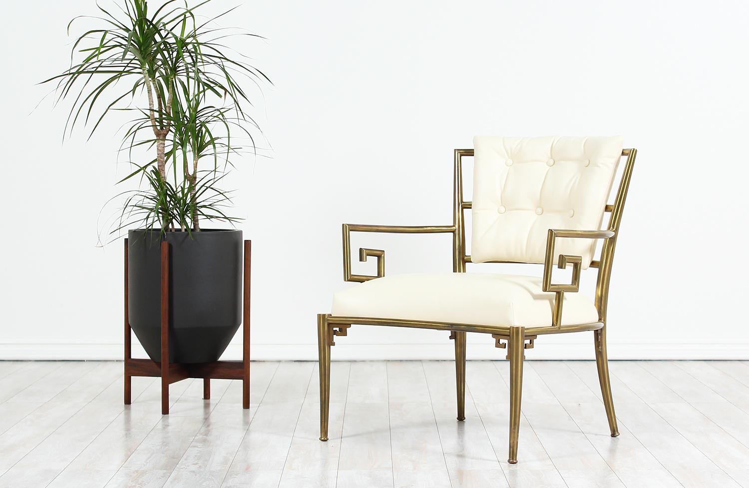 Elegant Brass lounge chair designed by Warren Lloyd in Italy and imported by Mastercraft circa 1970’s. Featuring an all brass frame with a striking Greek scroll design. The metal frame shows a nice patina which gives it character and adds to its