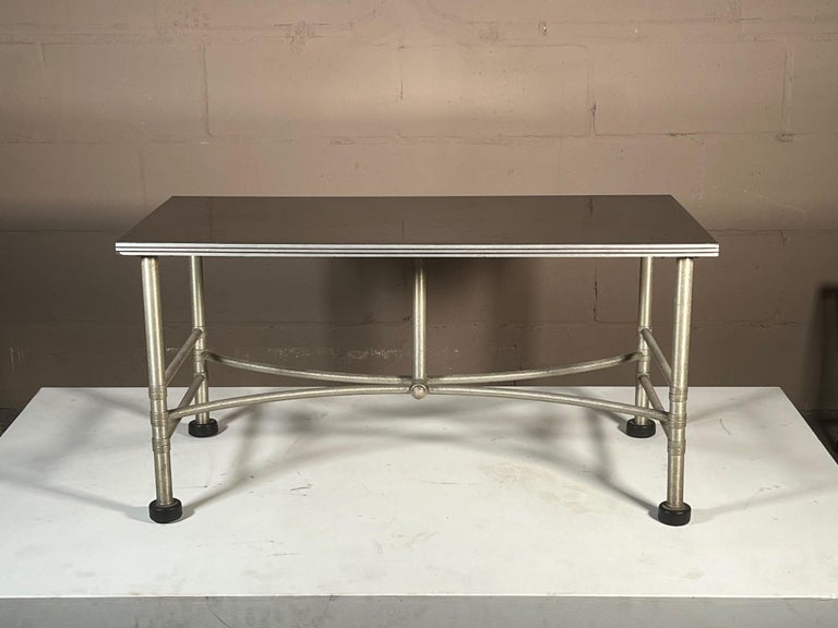 Unusual Warren McArthur coffee table with architectural, machine age base and original formica black top. Signed underneath.