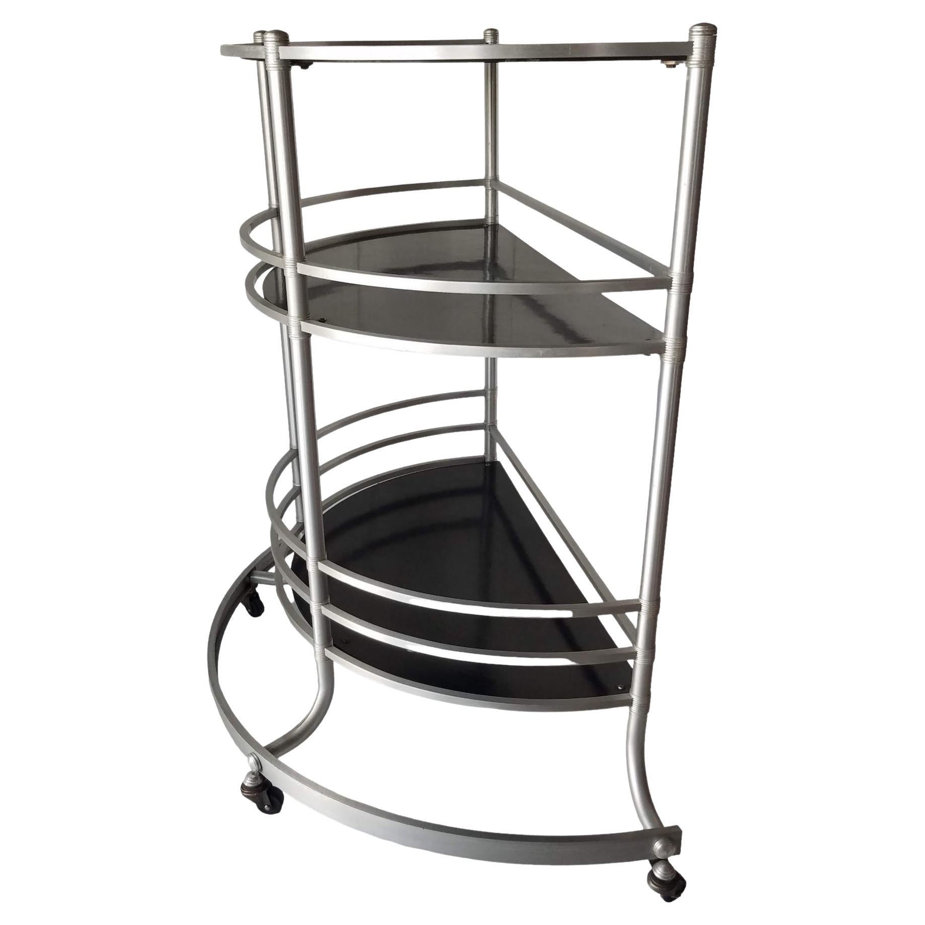 A Warren McArthur modernist rolling bar cart manufactured during the first years Warren was located in Rome, New York.
The Warren McArthur Corporation moved from Los Angeles to Rome, New York in January of 1933.

The label ending in 