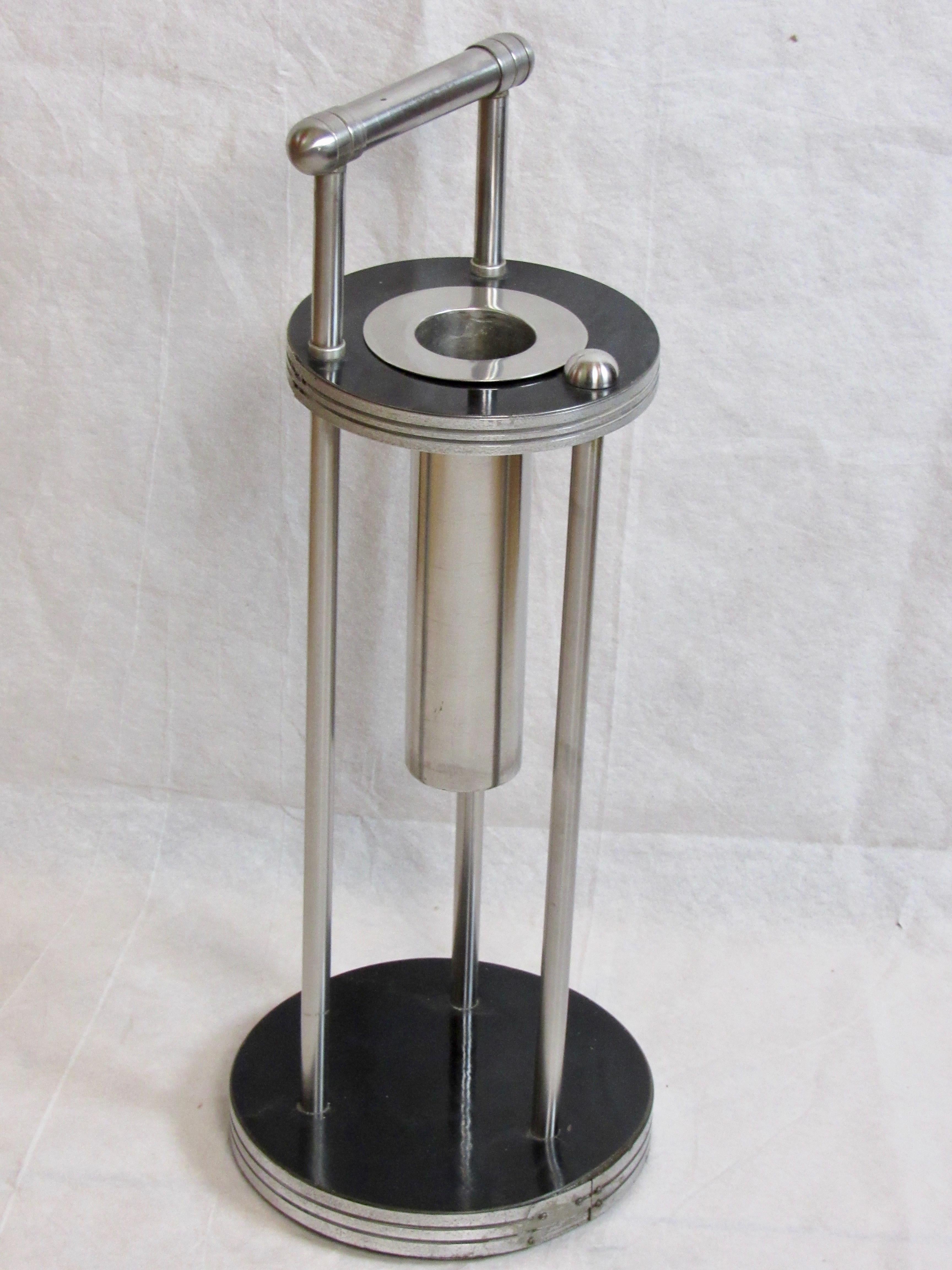 A Warren McArthur smoking stand framed in stainless steel from the early mid 1930's with A Rome, New York 
