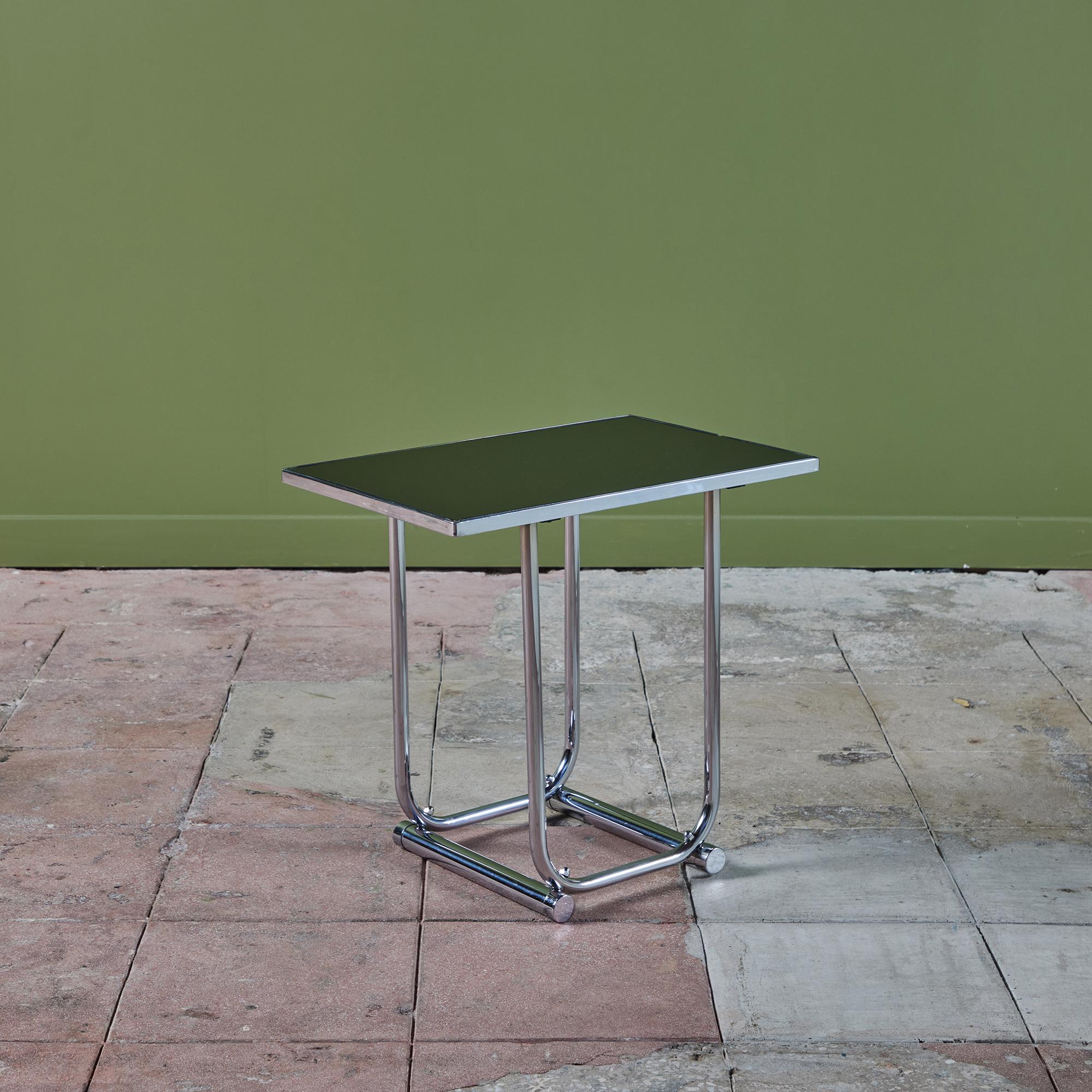 Art deco rectangular side table in the style of Warren McArther. The table features a bent tubular steel frame with a black glass table top.

Dimensions
20