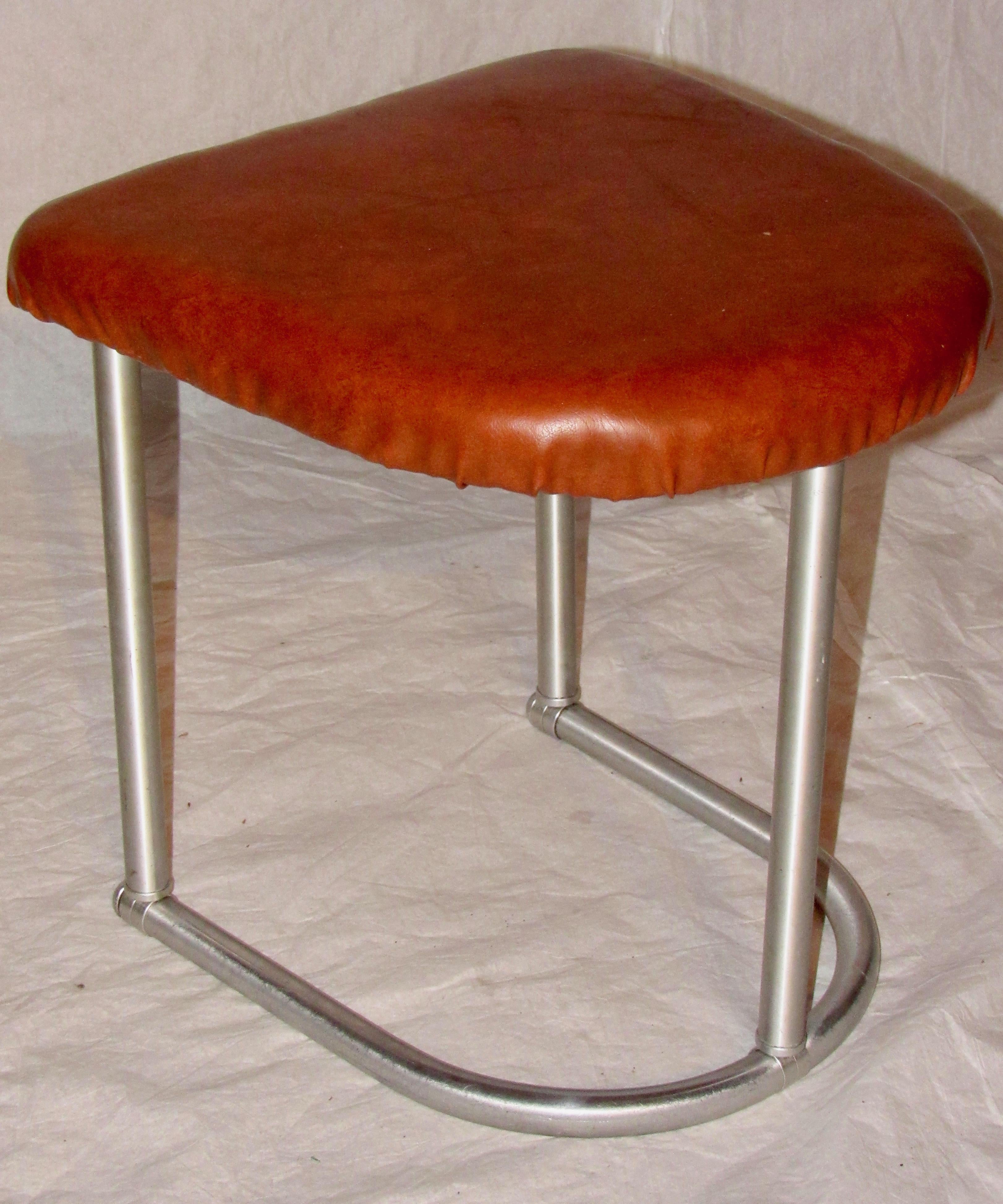 Warren McArthur aluminum vanity stool from the mid- 1930s.
The stool is worn and has a separation crack on the inside edge of one of the floor tube. Early McArthur is made from welded tube which can separate over time. The seat cover is probably 50