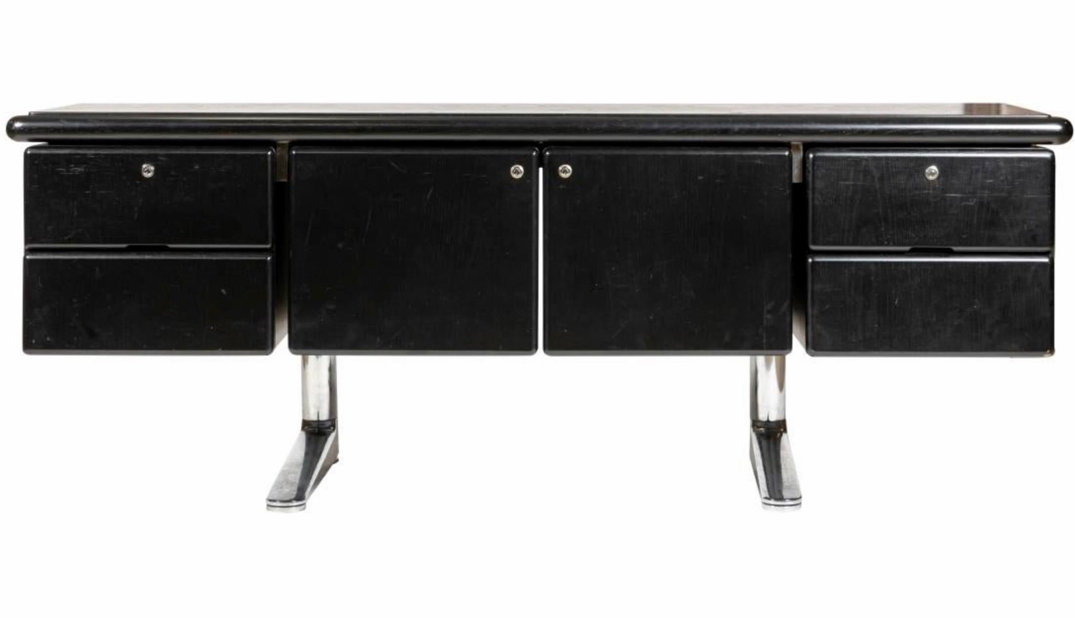 Handsome black oak sideboard designed by Warren Planter and manufactured by Knoll International, in 1973. Entire piece rests on top of two cantilevered chrome legs. 2 drawers flank each side of the sideboard with a cupboard in the middle. Entire