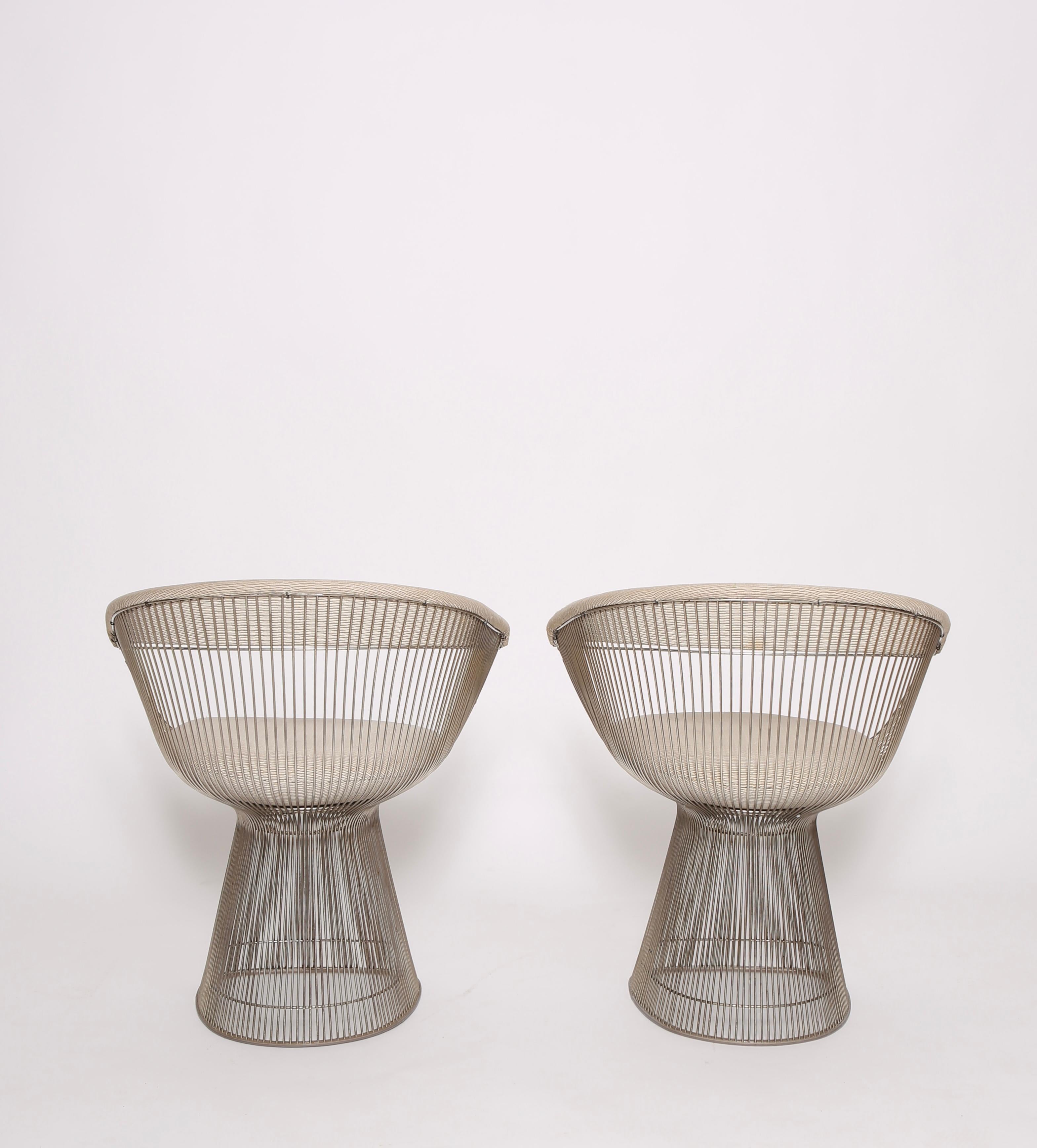 Nice vintage pair of nickel finish dining chairs by Warren Platner for Knoll circa 1960s. Upholstery was updated in the 1990s but shows signs of use and it is recommended that these be reupholstered upon purchasing. 
Frames are in good condition