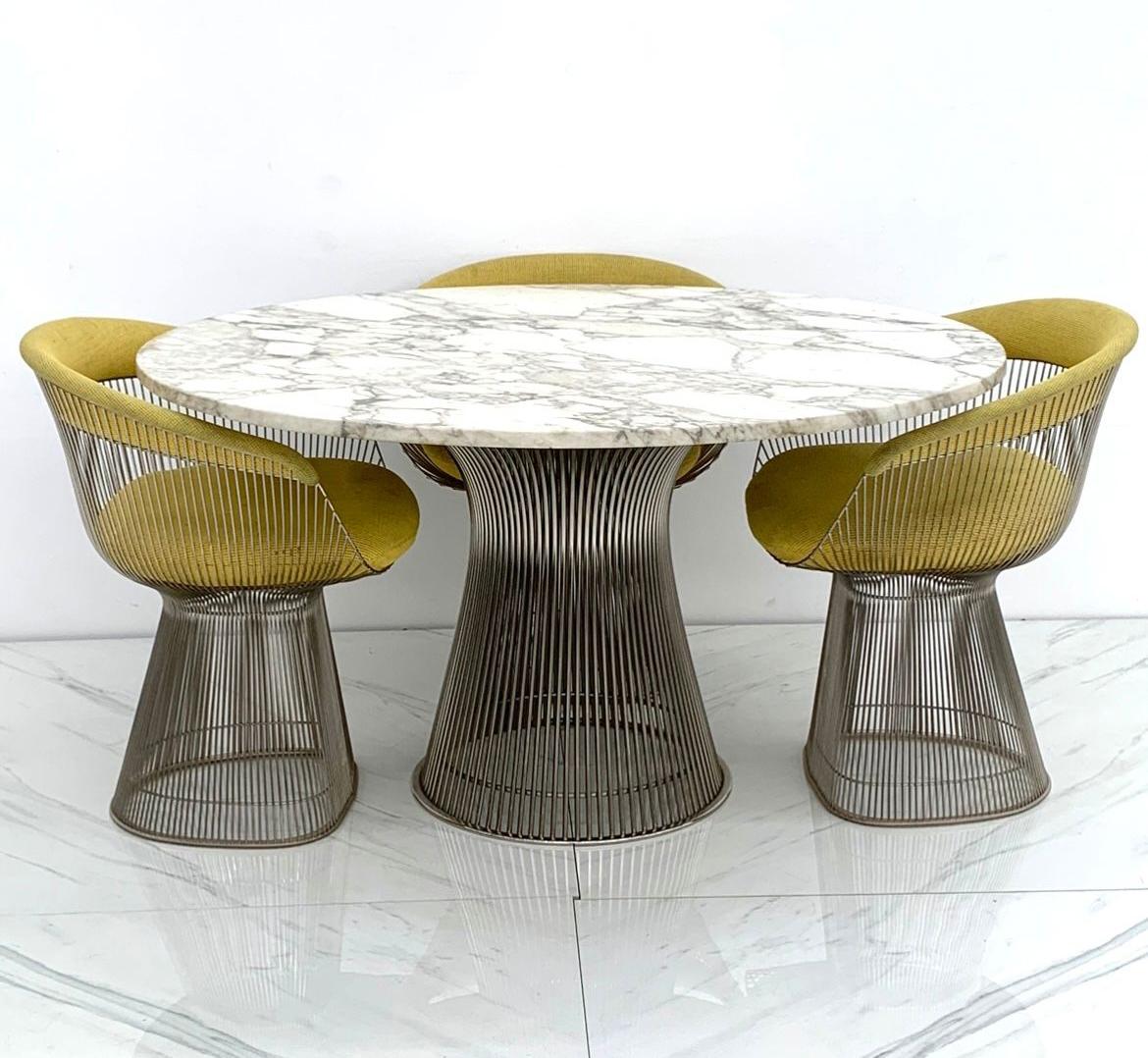 A truly stunning dining table, Warren Platner for Knoll polished nickel and steel base dining table with a stunning veined Italian Arabescato marble top. This original 1960's dining table came from a Scottsdale estate with 1 owner where it sat until