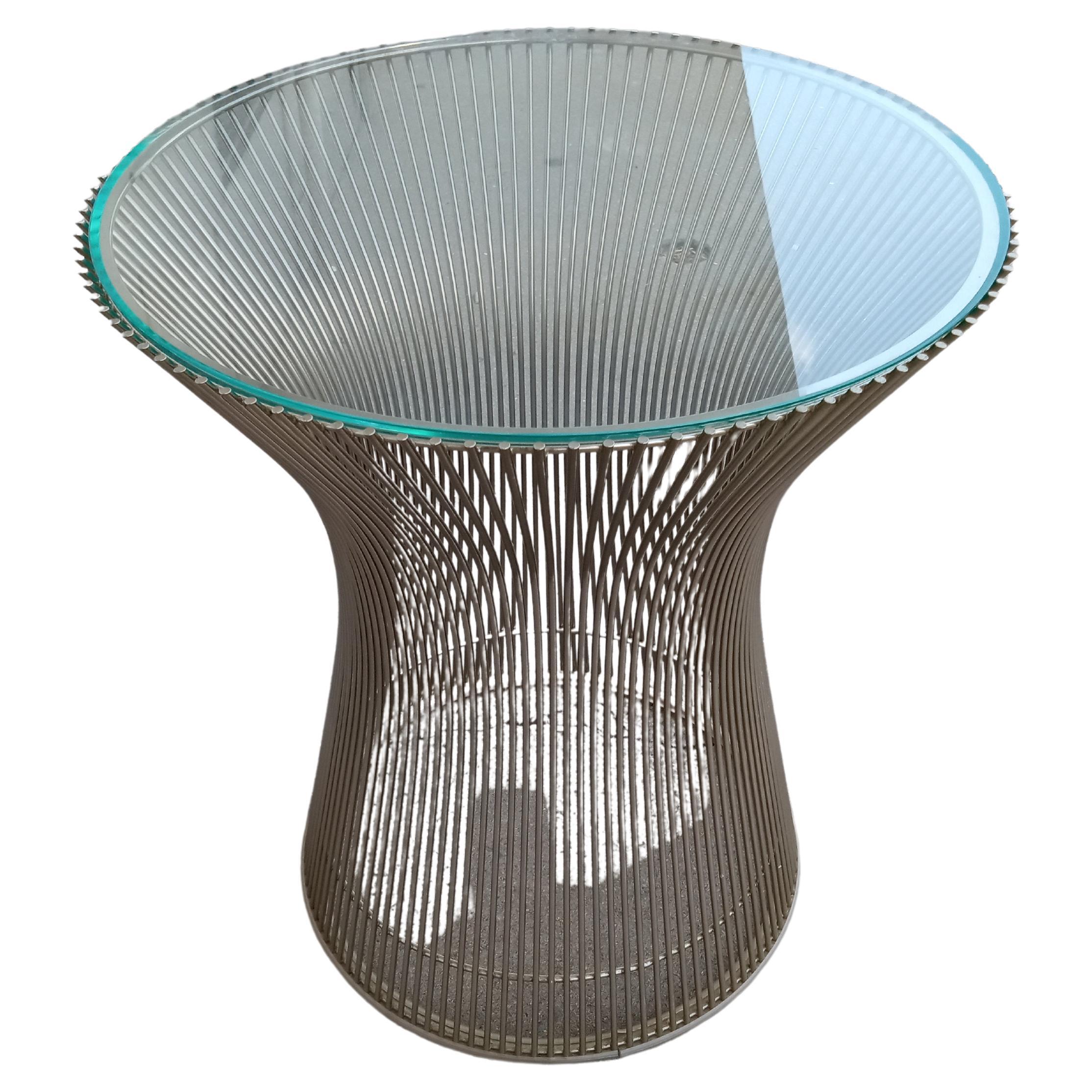 This is the iconic design by Warren Platner for Knoll Furniture. This side table has a glass top that sits atop the iconic base that's made of nickel plated steel. The steel wire forms a cone curve that Warren Platner is famous for.

A nice addition