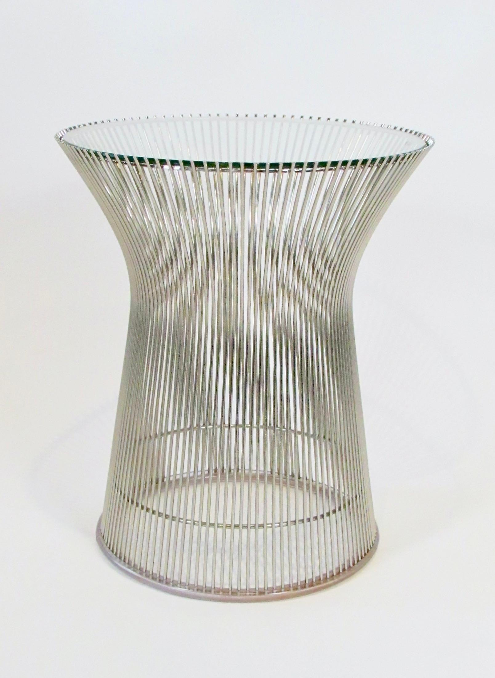 Warren Platner designed collection for Knoll was introduced in 1966 . The frame of the Platner table collection features vertical steel wire rods welded to circular horizontal and edge-framing  form at top and bottom . The Base has a clear plastic