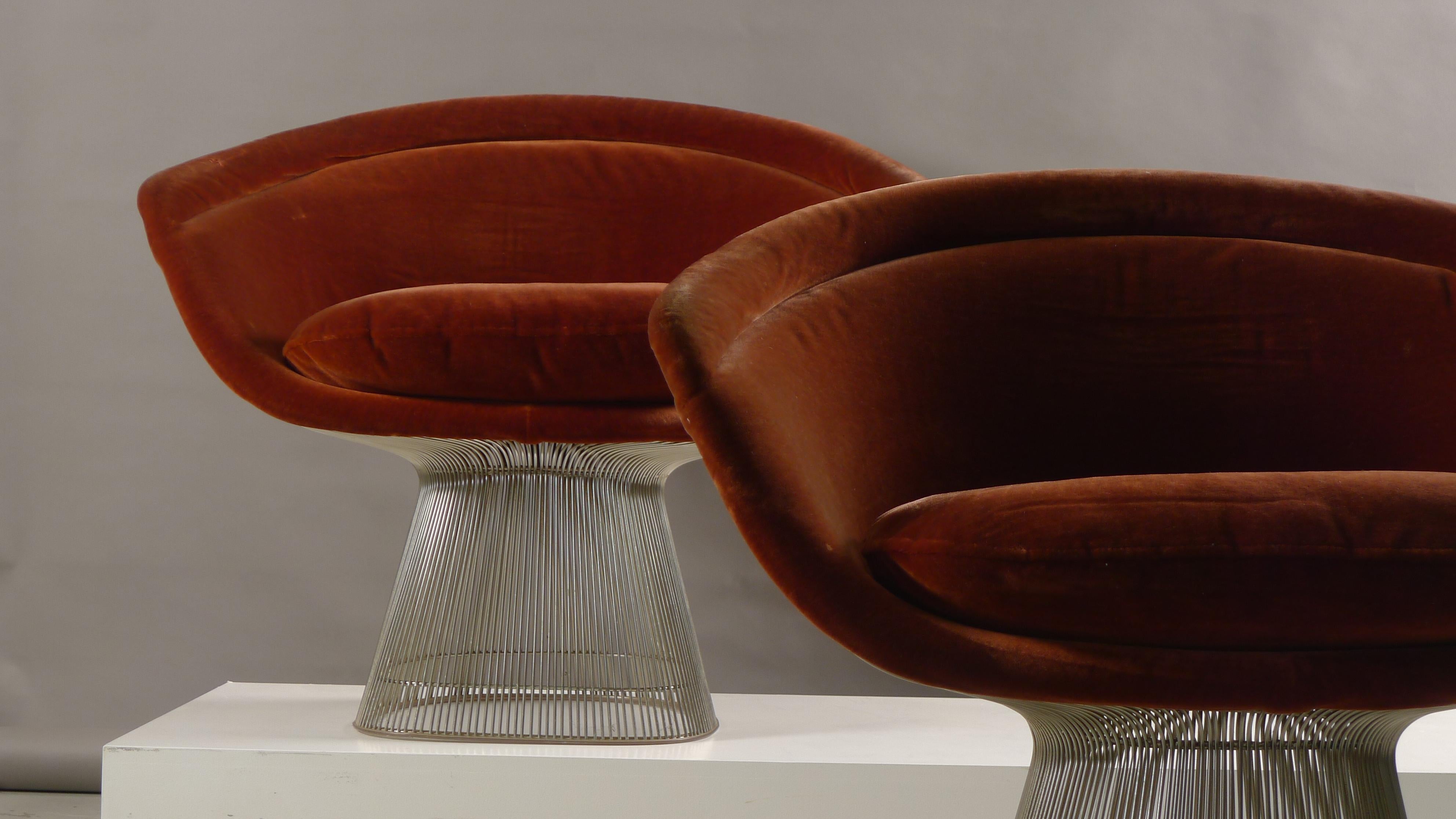 Warren Platner for Knoll International, USA , 1966. A pair of lounge armchairs in burgundy velour over chromed steel frames. Labels to underside of seats as shown. 
Slight pull to the fabric on one arm on one chair. No rust.