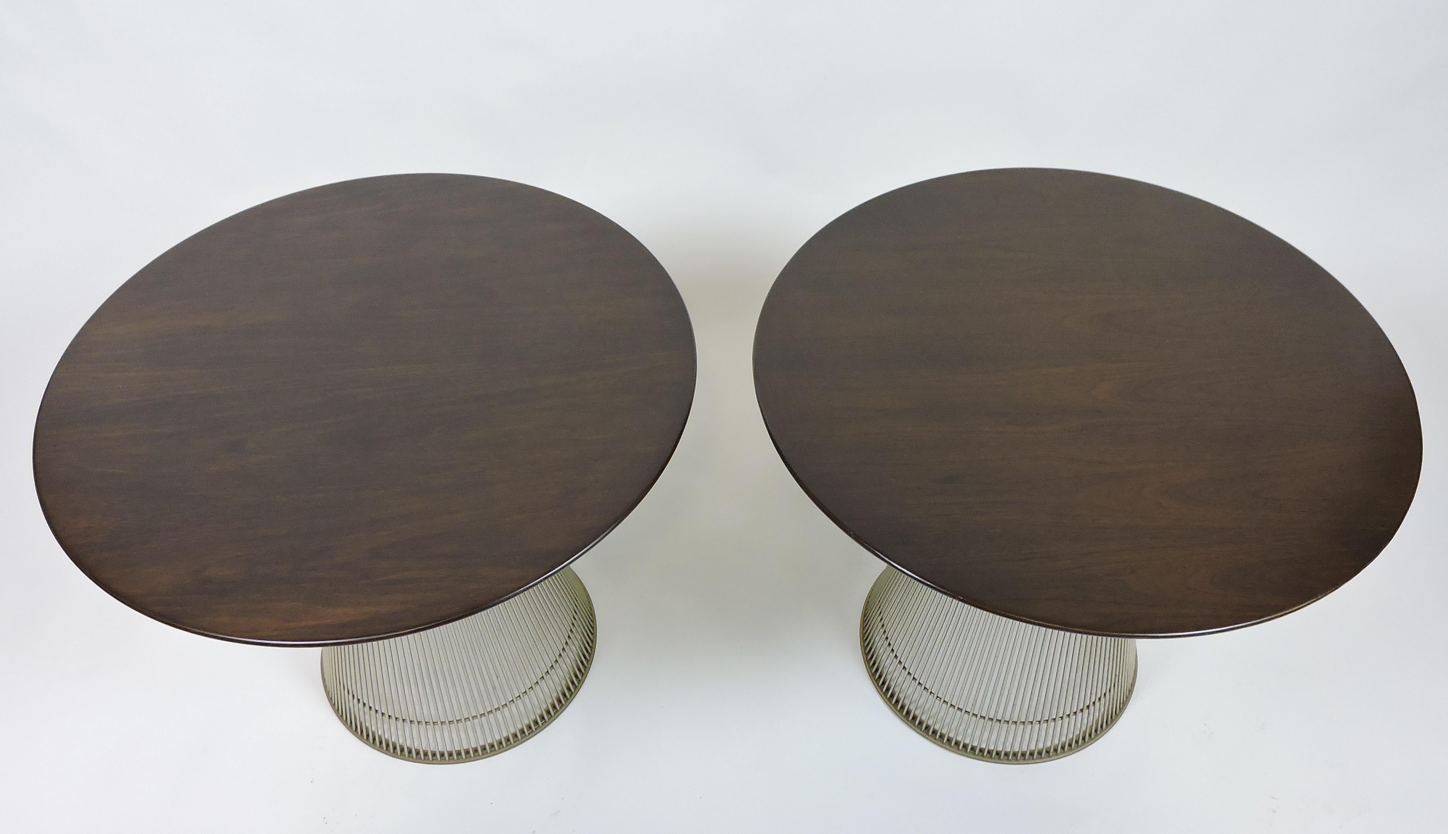 Pair of beautiful Warren Platner wire end or side tables manufactured by Knoll. These are the earlier tables with a larger walnut top that hangs over the edges of the wire base, and which are no longer manufactured. Both labeled with early Knoll