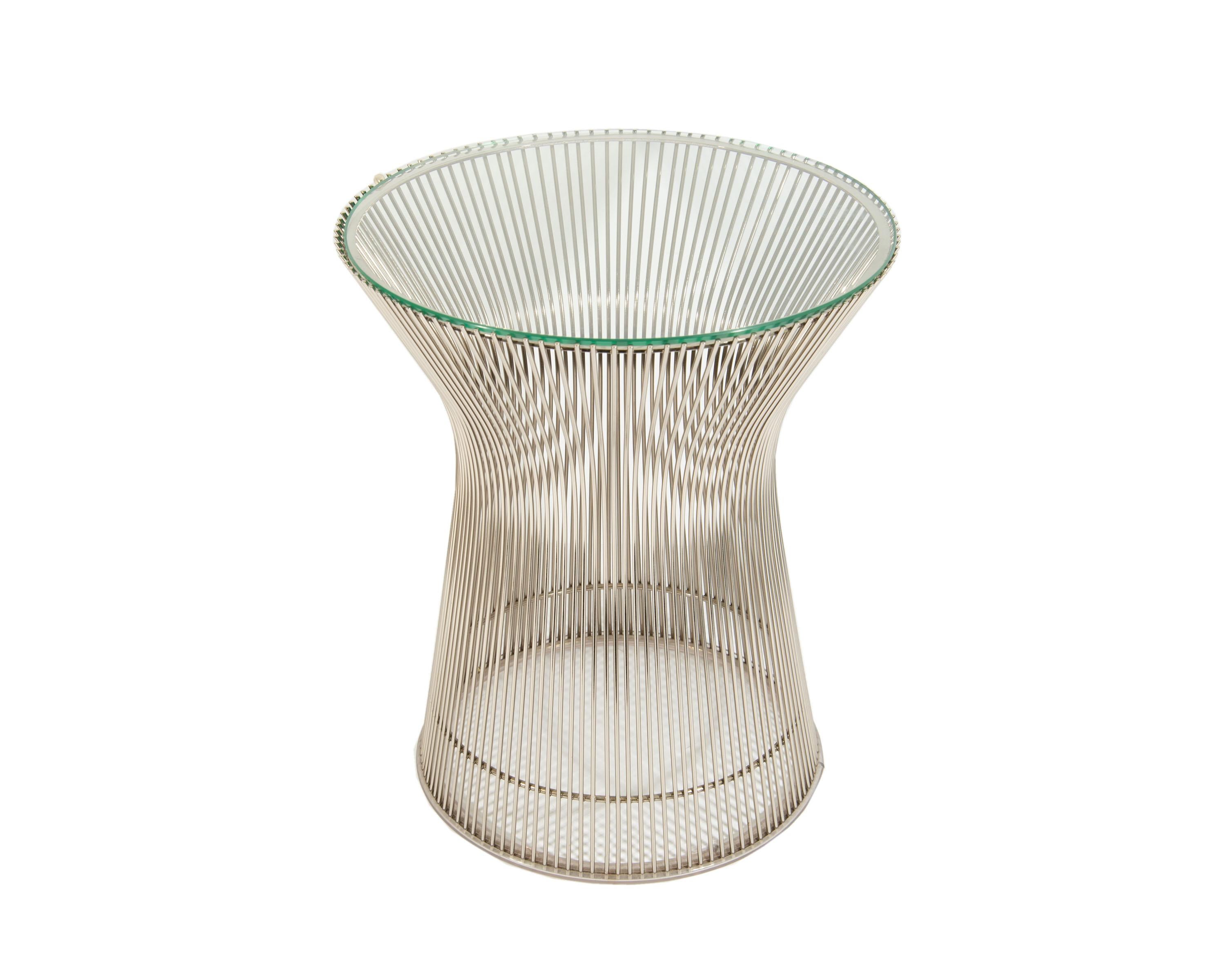 A vintage steel and glass side table designed by American architect and designer Warren Platner (1919-2006) for Knoll. The table design originated in 1966 and features multiple welded curved steel rods attached in a vertical pattern to a circular