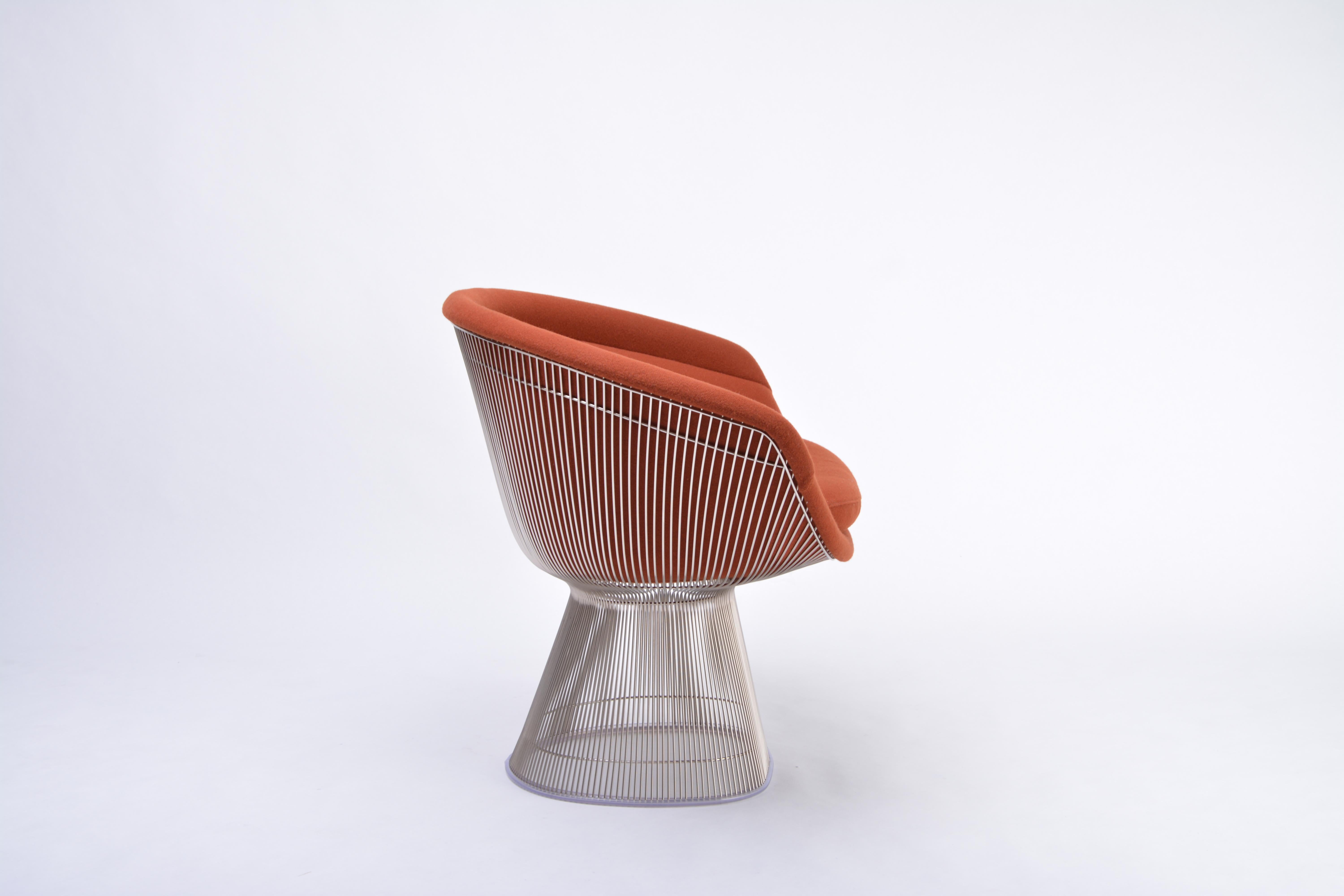 The lounge chair was designed by Warren Platner in 1966. The base is made of steel wire rods with nickel finish who are protected with clear lacquer. The base is covered with a clear plastic extrusion ring for smooth bottom surface. The seating