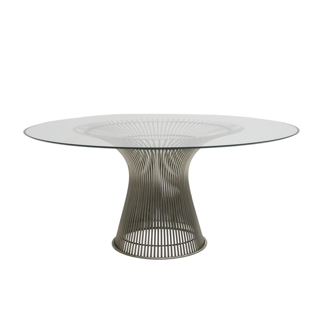 Dining table designed by Warren Platner edited by Knoll, composed of a steel structure with welded rods creating curved shapes and circular glass top. USA 1970s.

Warren Platner studied at Cornell University, graduating in 1941 with a degree in