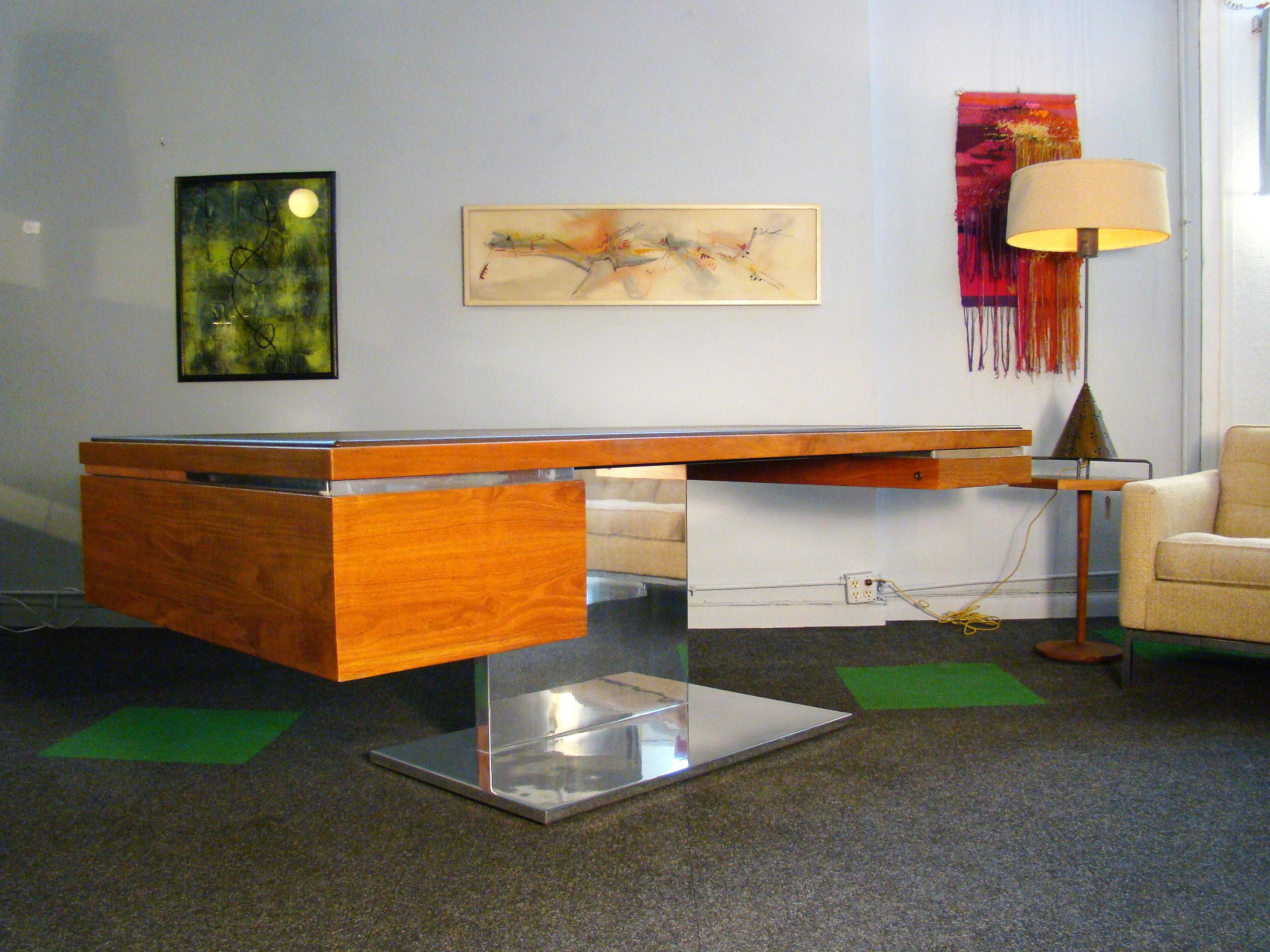 Magnificent midcentury executive desk by Warren Platner for Lehigh-Leopold / Litton (USA) in teak veneers, walnut solids, leather and polished stainless steel. Designed in the late 1960s, this example was made to order in 1983 at a cost of