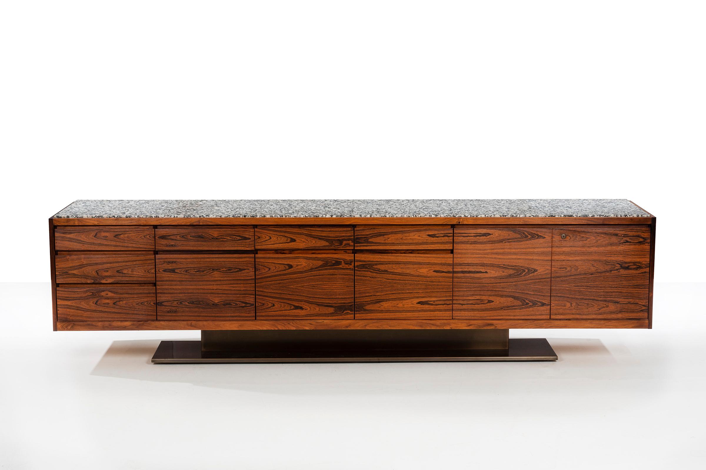 Exceptional monumental bookmatched highly figured rosewood veneer credenza by Platner for Lehigh Leopold. Composed of a three stacked drawer module, three file drawer modules with drawers above and double door section concealing three pull-out