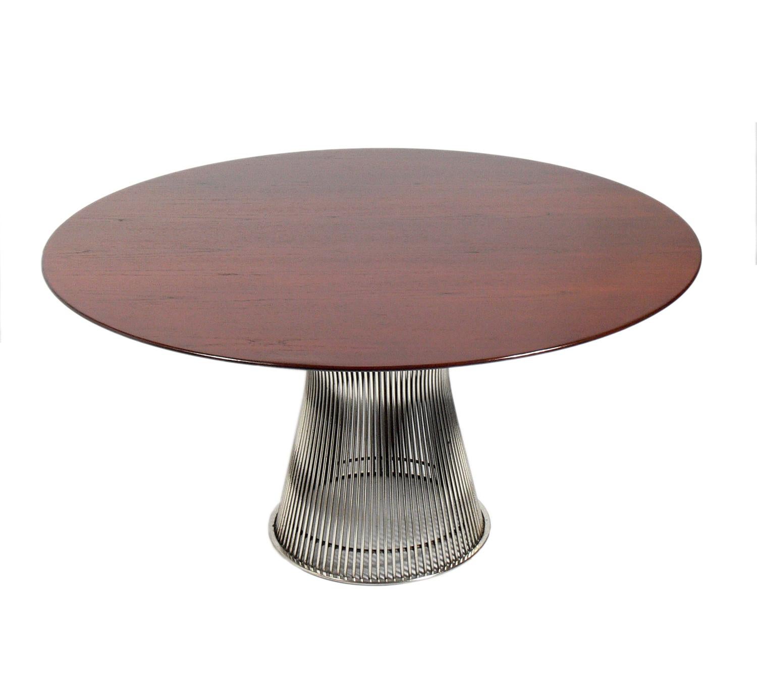 Sculptural walnut and chrome dining table, designed by Warren Platner for Knoll, circa 1960s. The walnut top has been refinished and exhibits beautiful graining. This listing is for the dining table only.