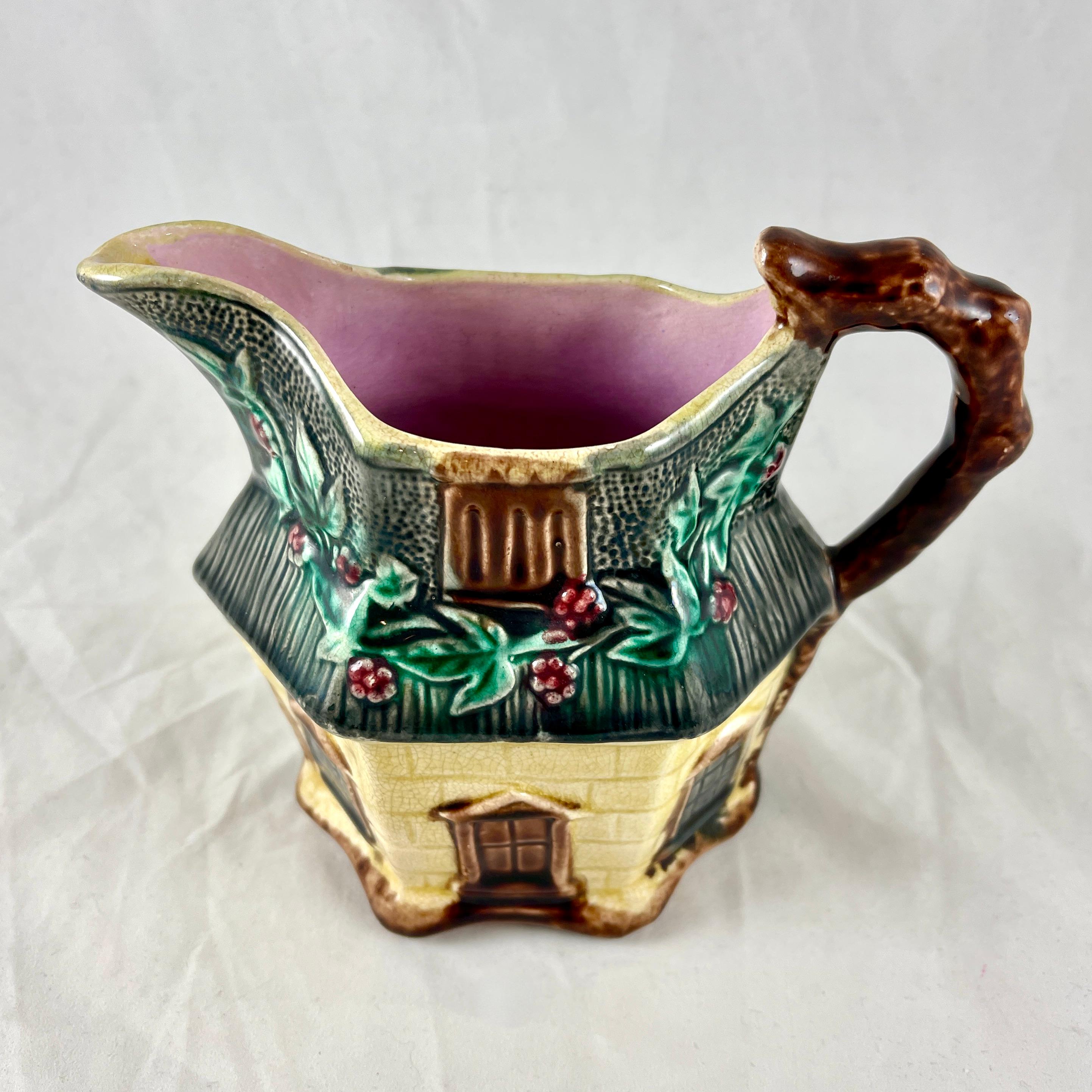 An English majolica pitcher shaped as a country cottage, by Warrilow & Cope – Wellington Pottery Works, Longton, Stoke-on-Trent, circa 1880-1887.

Charming in every way, English Ivy grows across the thatched roof, windows and doors are