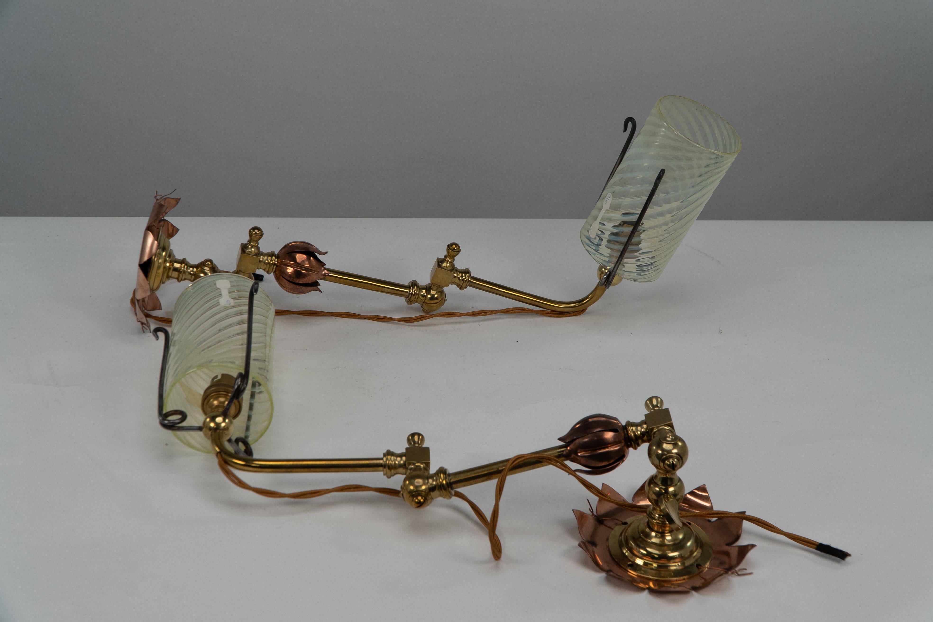 WAS Benson. A rare pair of copper and brass articulated wall lights with lily pad flower heads for the wall backplates retaining the original Vaseline shades. We have a spare Vaseline shade available priced separately at £450.
