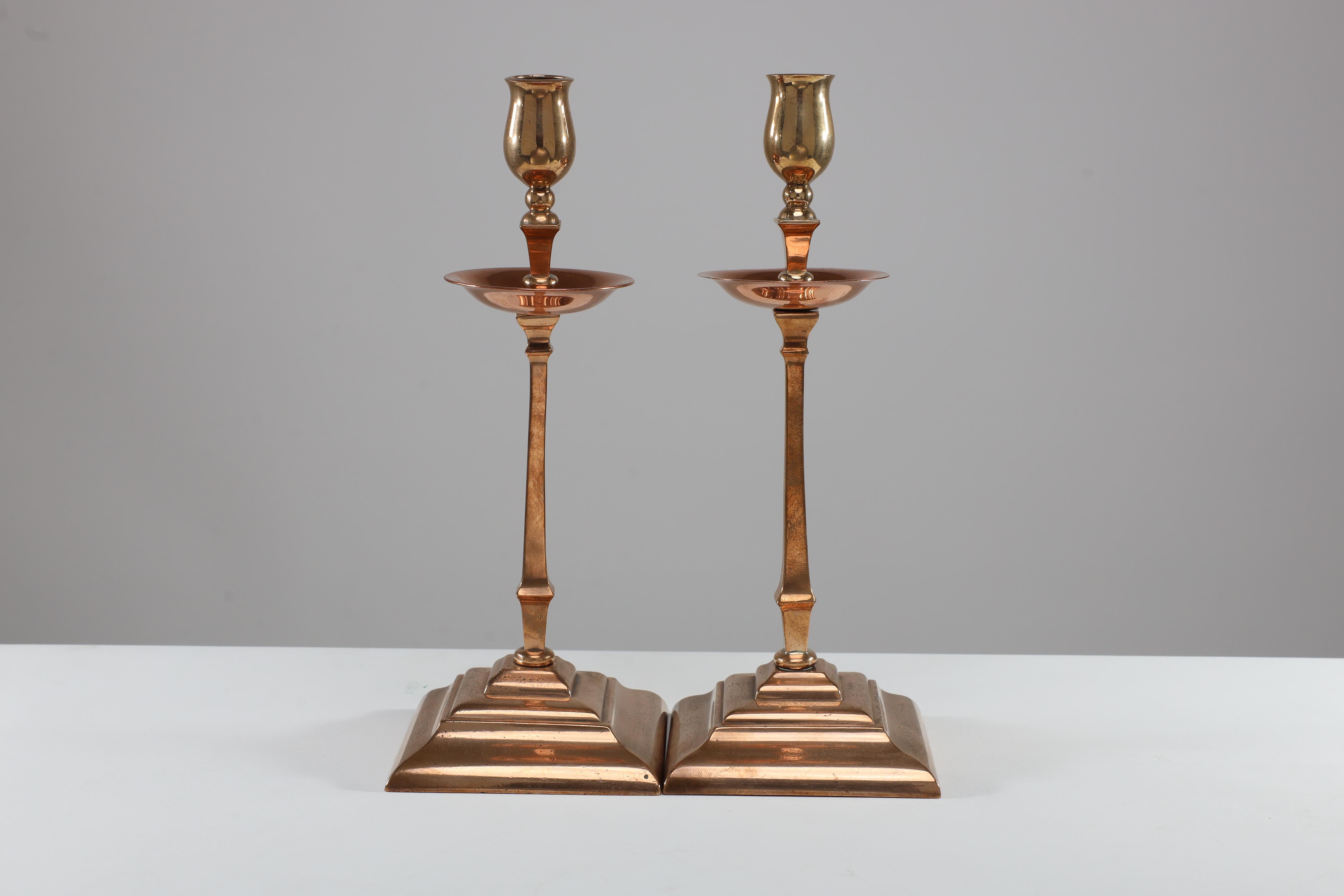 W A S Benson. A pair of Arts and Crafts copper and brass candlesticks. Price for the pair.