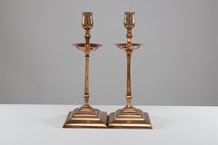 WAS Benson. A pair of Arts and Crafts brass and copper candlesticks